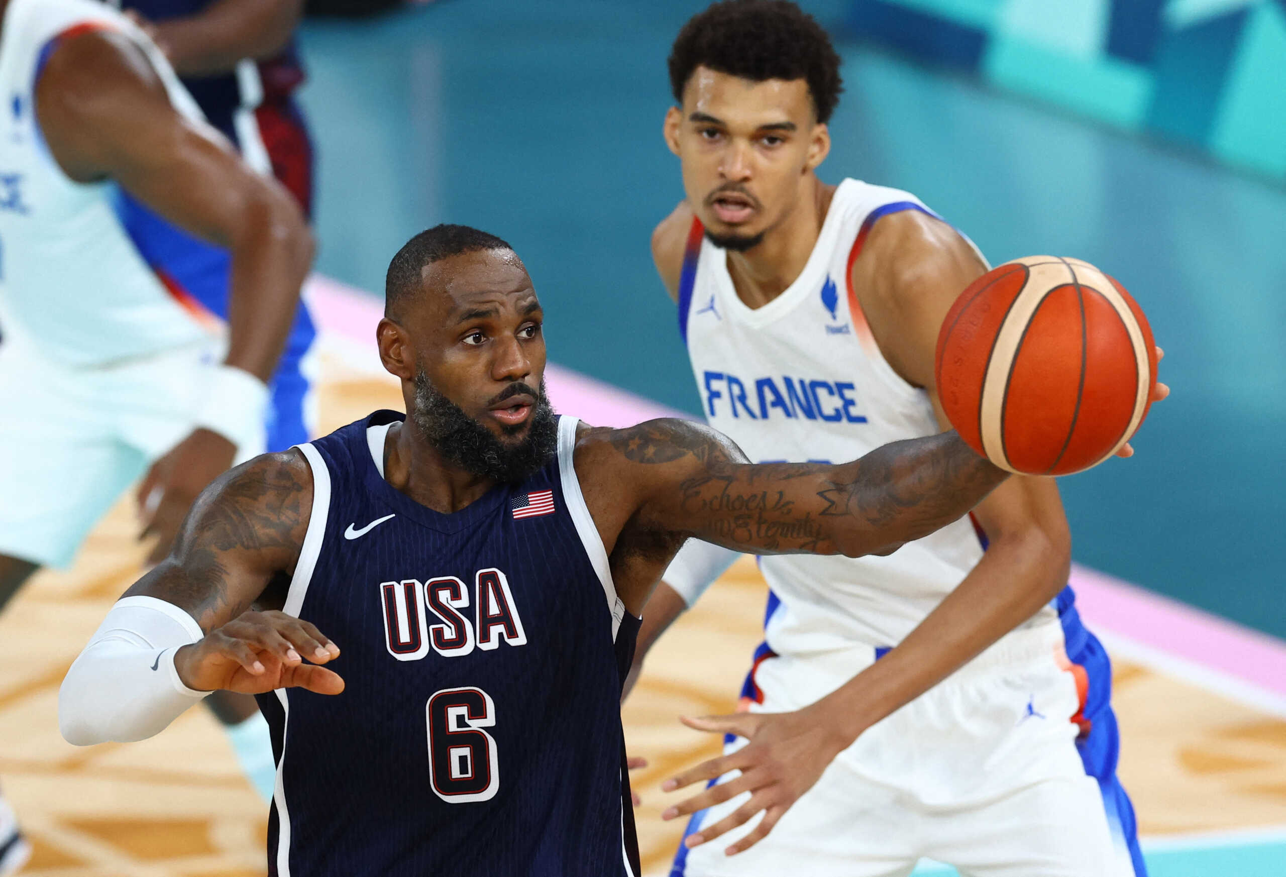 Paris 2024 Olympics - Basketball - Men's Gold Medal Game - France vs United States - Bercy Arena, Paris, France - August 10, 2024. Lebron James of United States in action with Victor Wembanyama of France. REUTERS