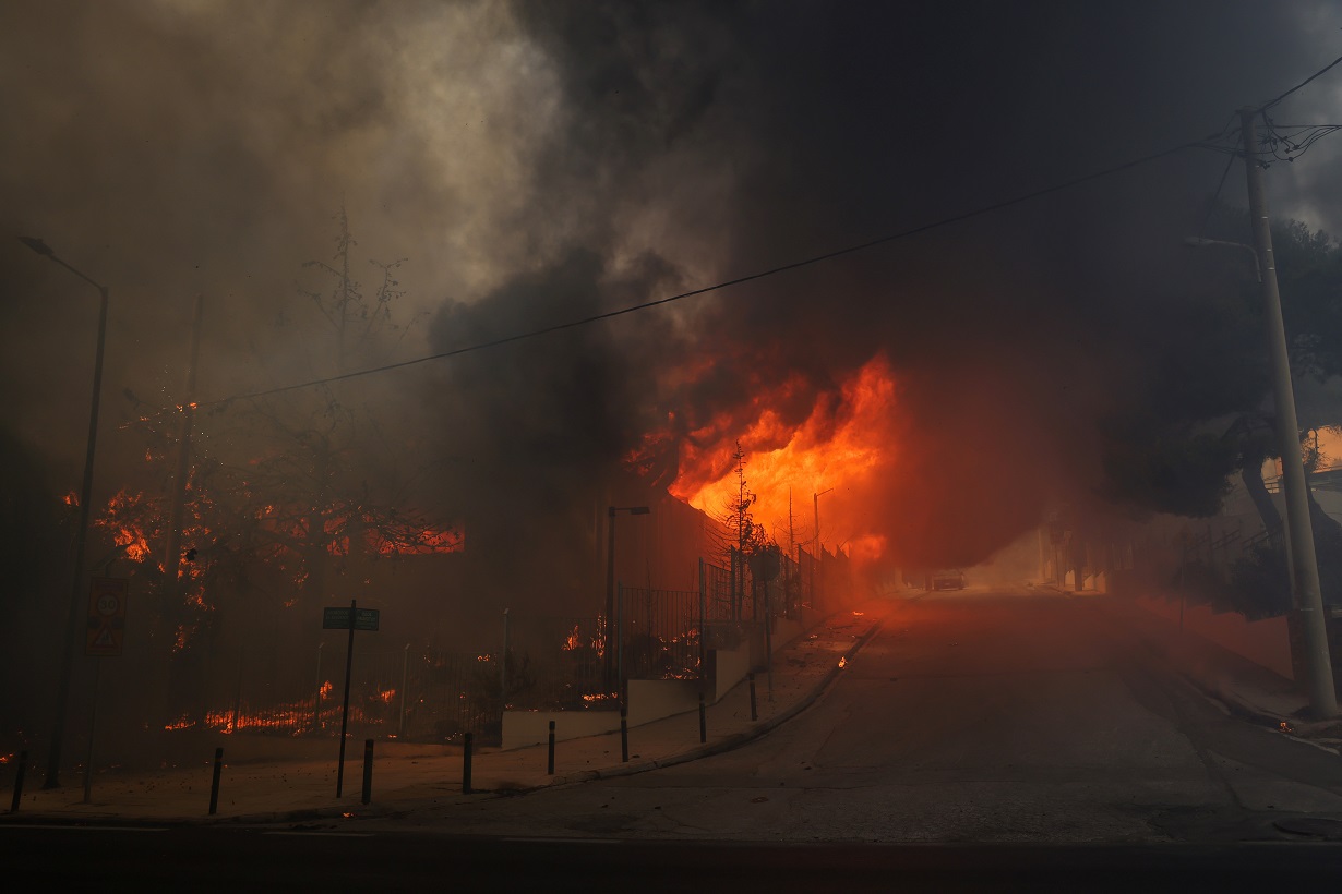 A high school building and its gym are seen in flames as a wildfire burns in Nea Penteli, near Athens, Greece, August 12, 2024. REUTERS