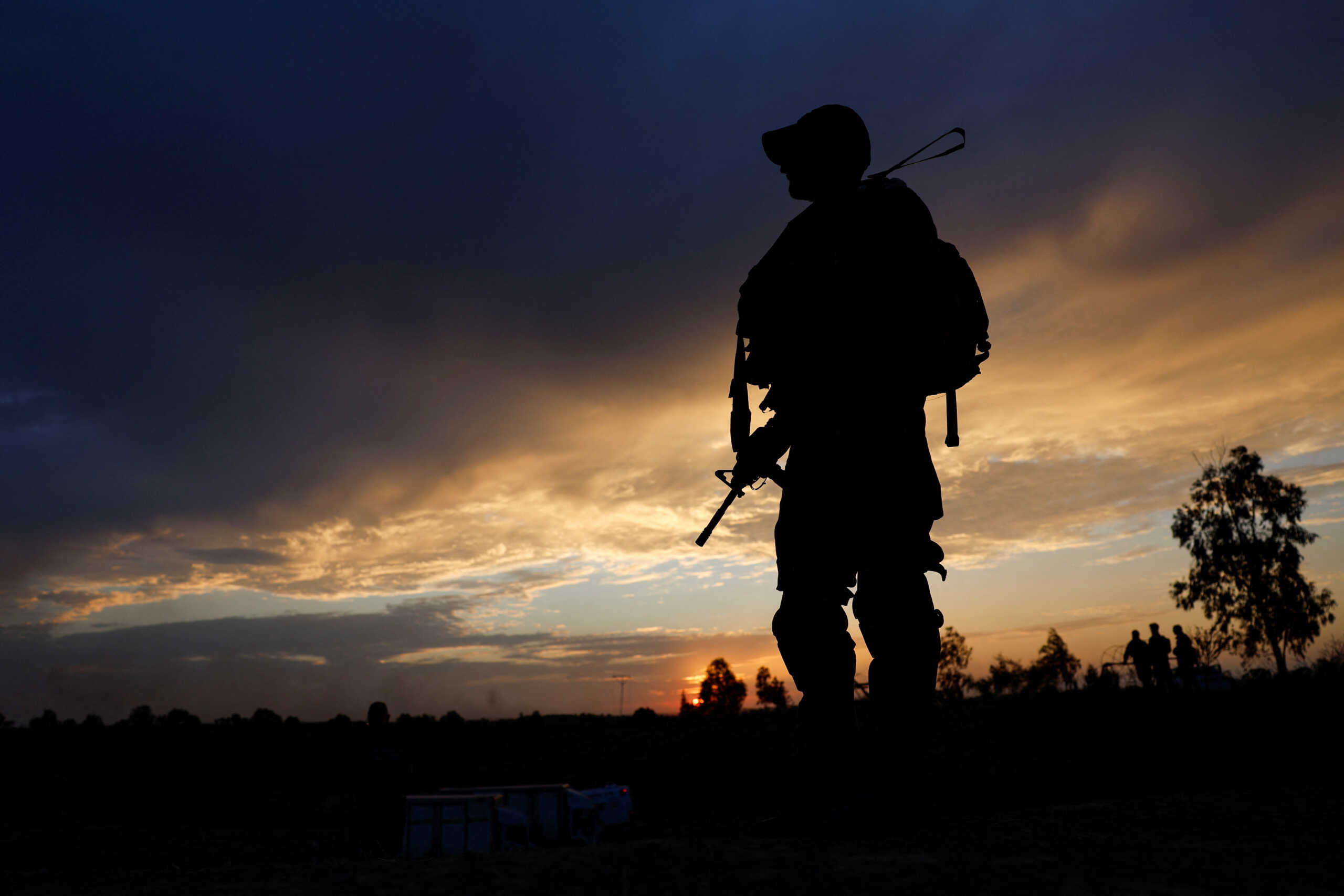 An Israeli soldier secures the area as family members and supporters of hostages who were kidnapped during the deadly October 7 attack, take part in a ceremony in an effort to bring back the hostages, outside Kibbutz Beeri, southern Israel, August 28, 2024. REUTERS