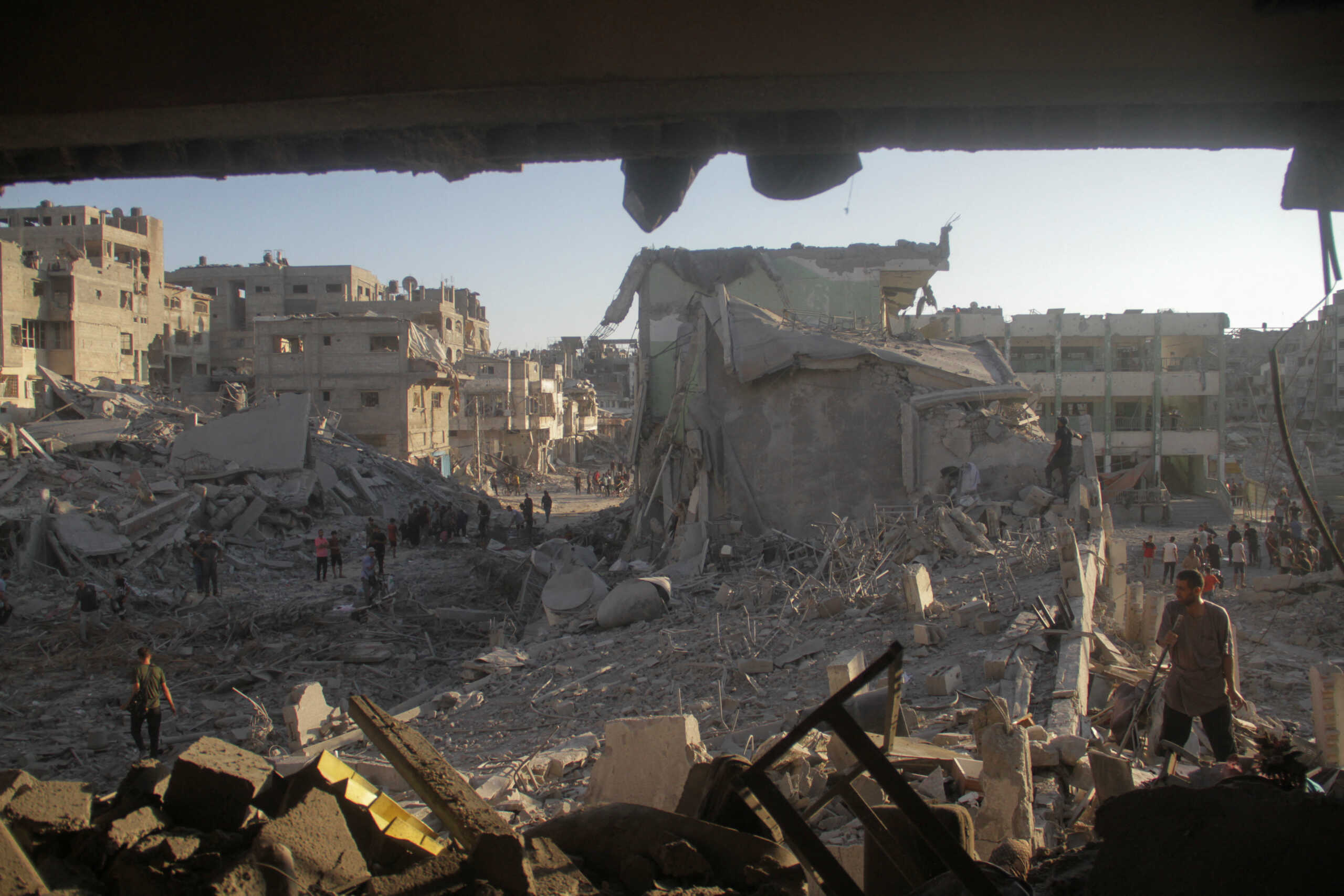 Palestinians inspect the site of Israeli strikes on a school sheltering displaced people, amid Israel-Hamas conflict, in Gaza City, August 3, 2024. REUTERS