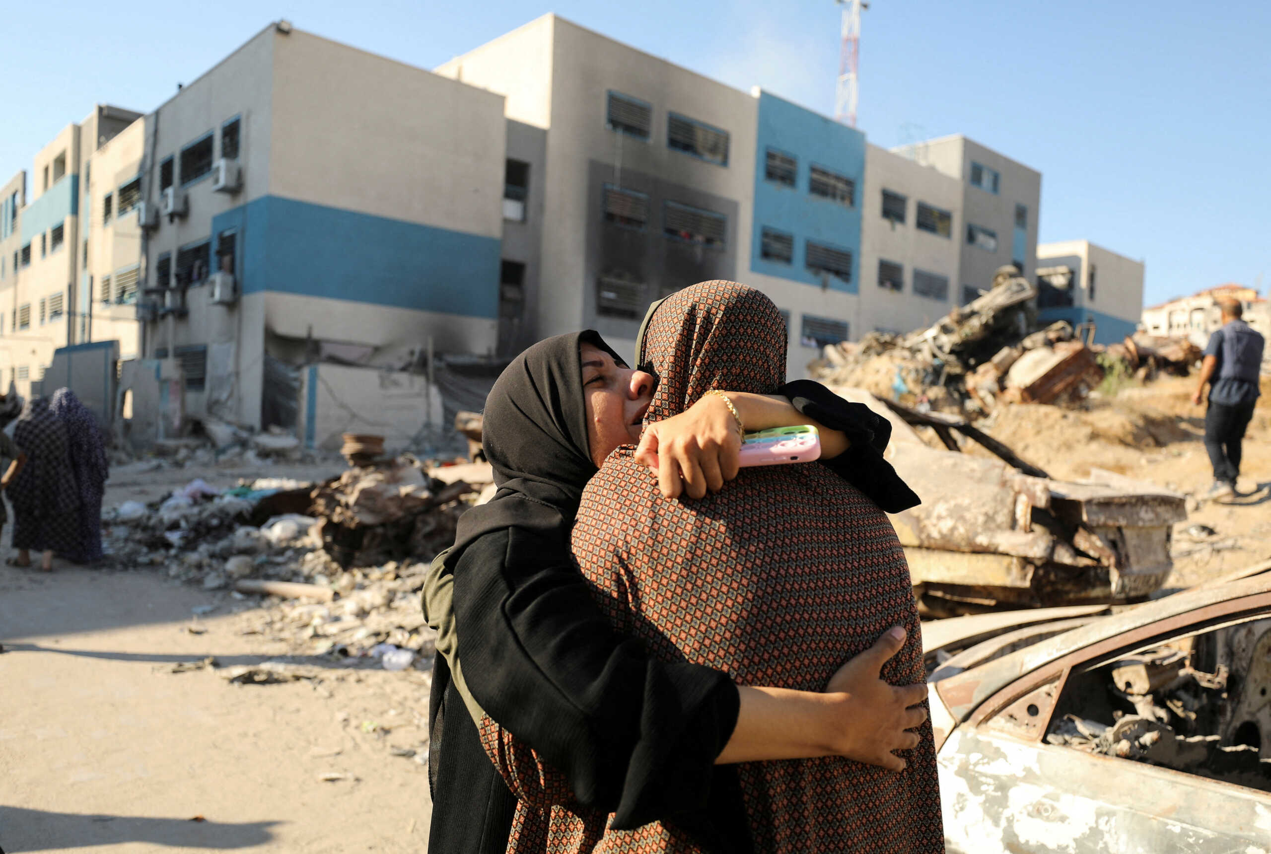 Palestinians react, after a school sheltering displaced people was hit by an Israeli strike, amid the Israel-Hamas conflict, in Gaza City, August 21, 2024. REUTERS