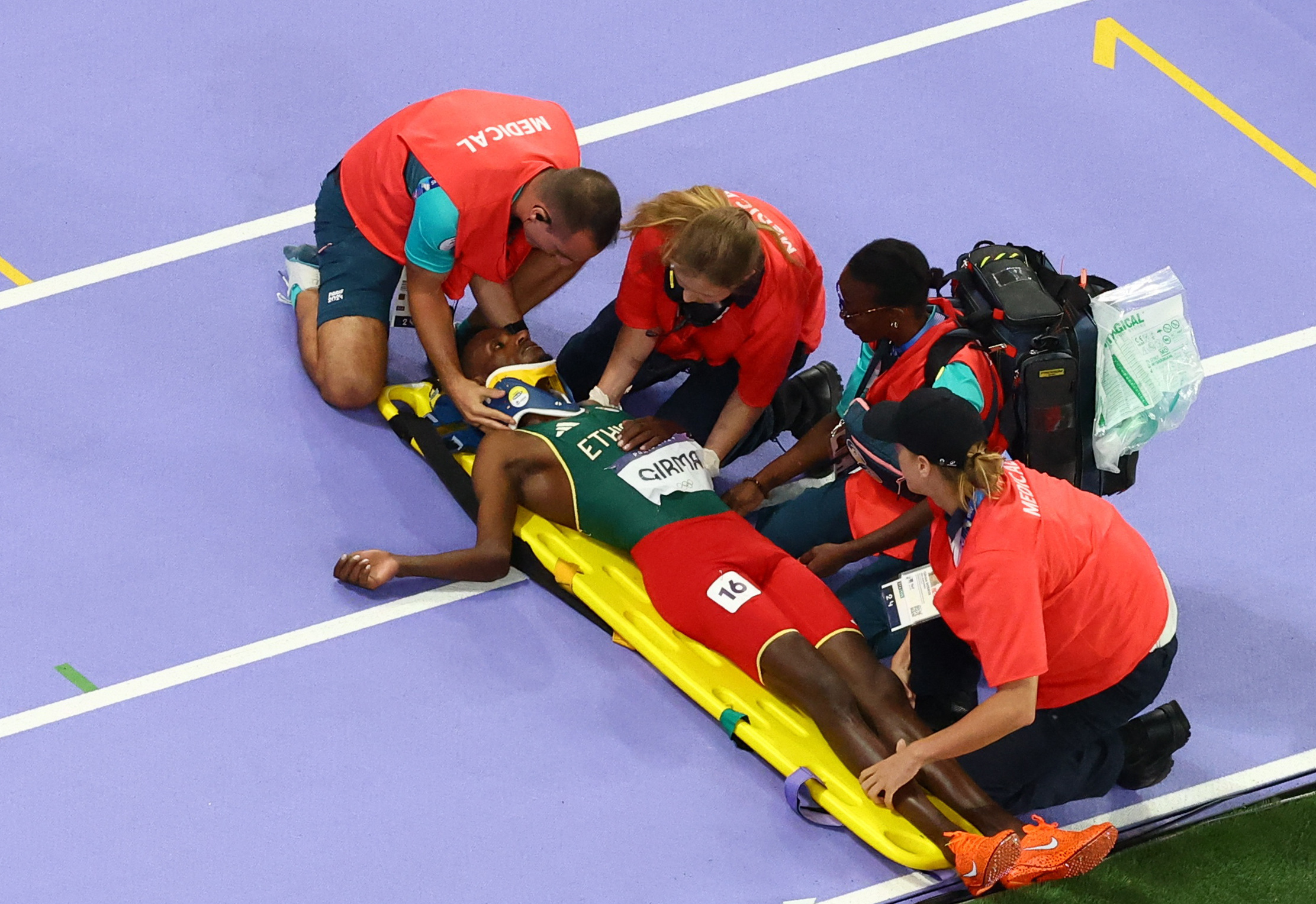 Paris 2024 Olympics - Athletics - Men's 3000m Steeplechase Final - Stade de France, Saint-Denis, France - August 07, 2024. Lamecha Girma of Ethiopia receives medical attention after sustaining an injury REUTERS