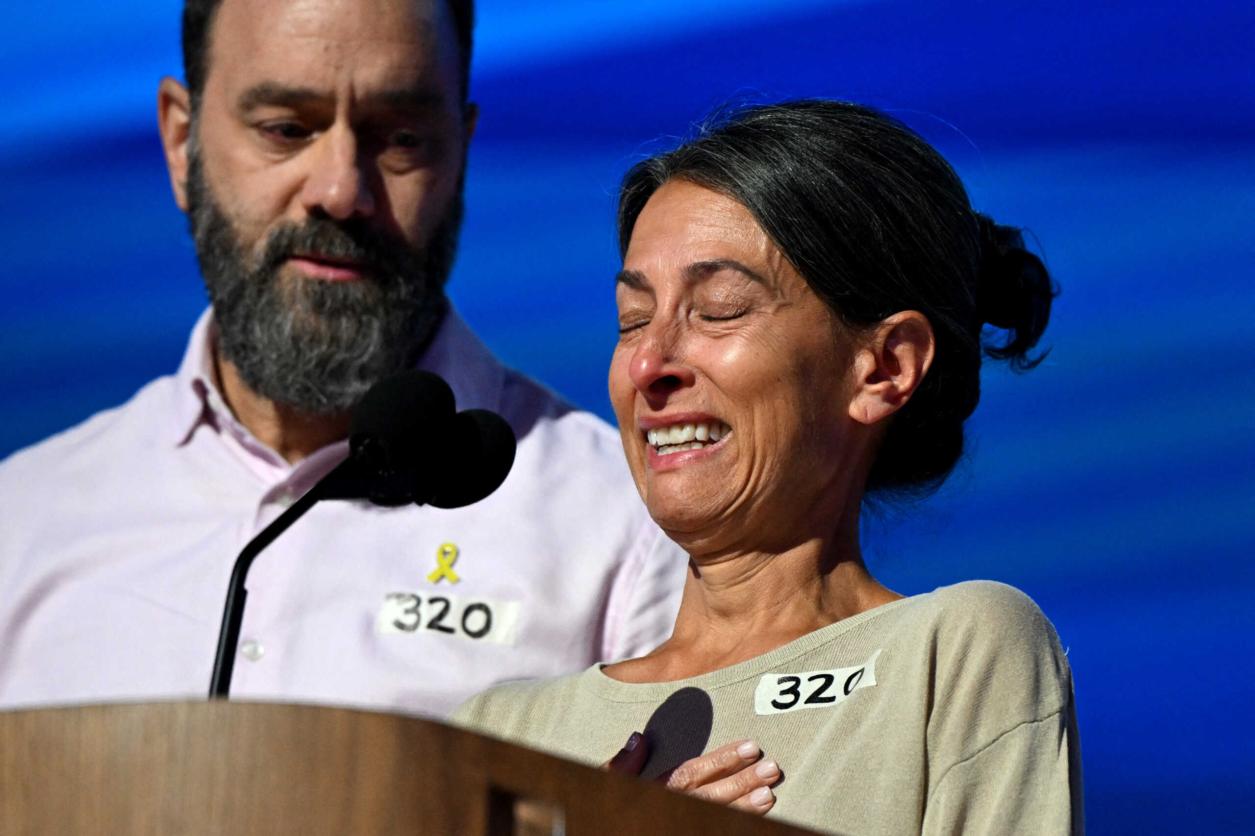 Rachel Goldberg, mother of Hersh Goldberg-Polin who is being held hostage in Gaza, reacts next to her husband Jon Polin as they take the stage on Day 3 of the Democratic National Convention (DNC) in Chicago, Illinois, U.S., August 21, 2024. REUTERS