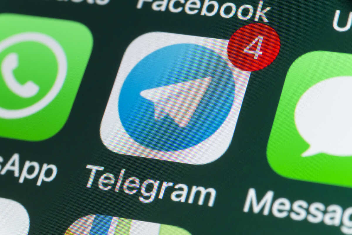 London, UK - July 30, 2018: The buttons of Telegram, WhatsApp, Facebook, Messages and other apps on the screen of an iPhone.