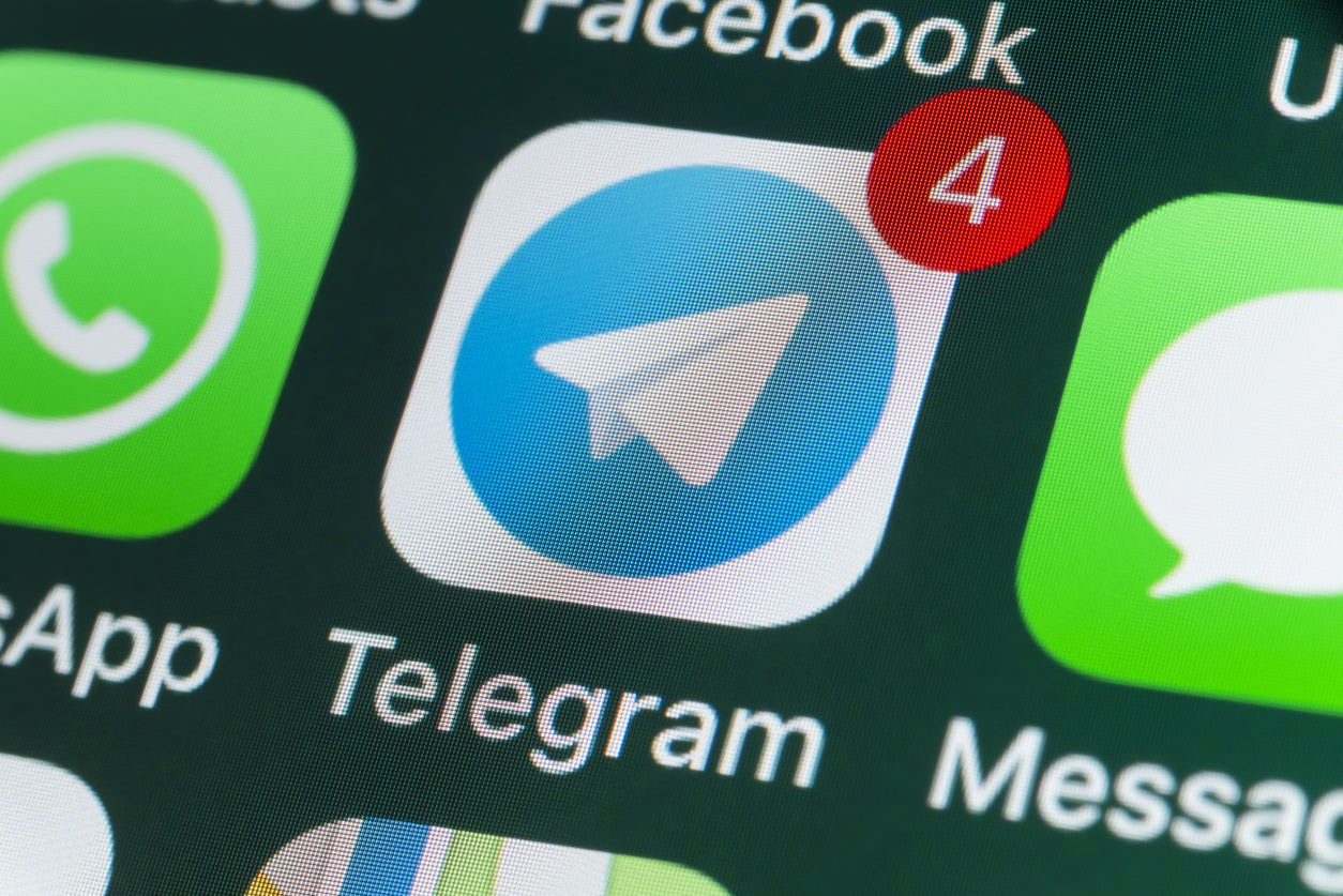 London, UK - July 30, 2018: The buttons of Telegram, WhatsApp, Facebook, Messages and other apps on the screen of an iPhone.