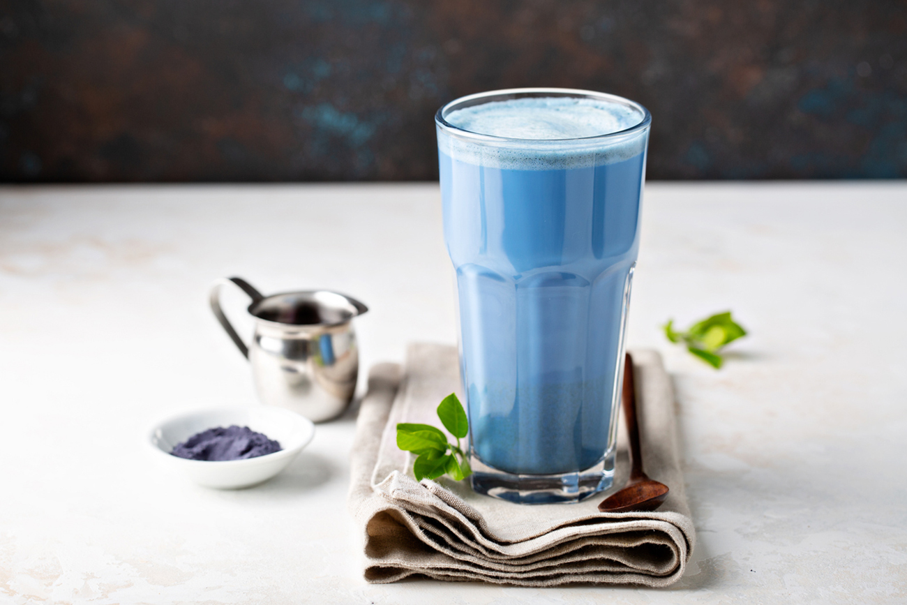 Blue matcha latte in tall glass, tea from the dried flowers of the butterfly pea plant