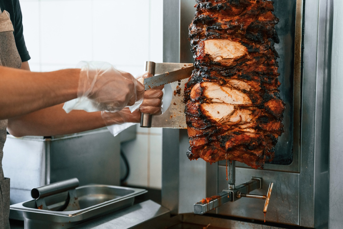 Chef preparing and making traditional Turkish Doner Kebab meat. Shawarma or gyros.
