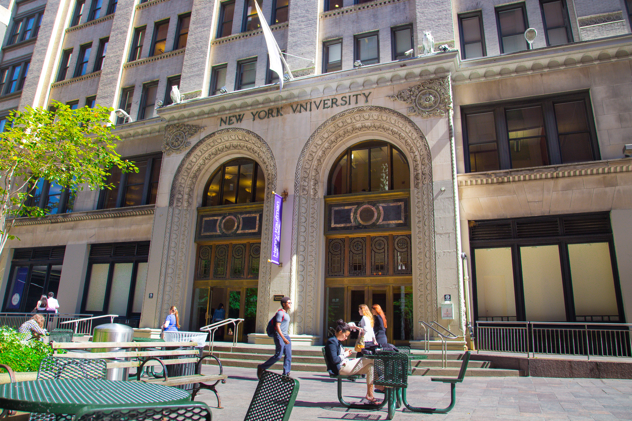 New York City, New York, USA - September 13, 2013:  People on the plaza outside the Kaufman Management Center of Stern Business School at New York University in Manhattan.  The Stern School at NYU is one of the oldest and most prestigious business schools in the world.