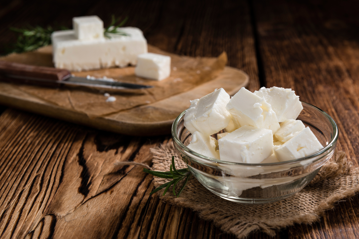 Fresh Feta Cheese (detailed close-up shot) on vintage background