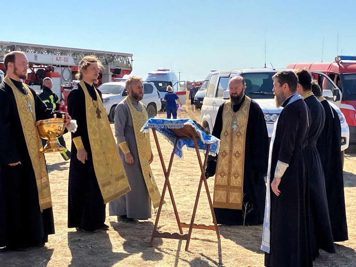 Russian Orthodox clergymen conduct a service around the Unburnt Bush icon, which is considered by Christians in Russia as a talisman against fire, near the accident site at the Proletarsk fuel depot that caught fire following a reported Ukraine's drone attack in the course of Ukraine-Russia conflict, in the Rostov region, Russia, in this handout picture released August 21, 2024. Volgodonsk Eparchy of Russian Orthodox Church