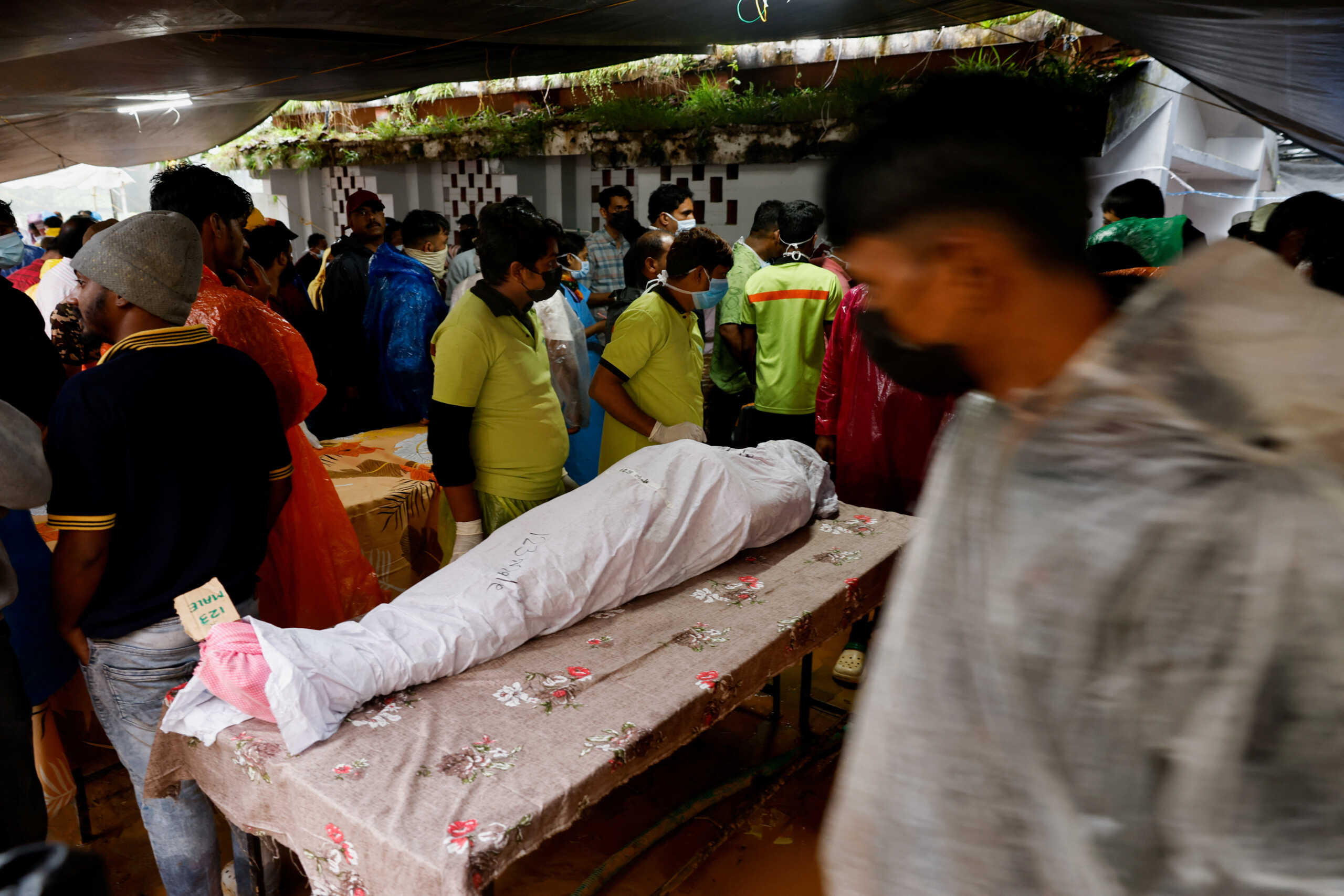 An unidentified body is placed on a table  at a hospital to be claimed after several landslides hit the hills in Wayanad district, in the southern state of Kerala, India, July 31, 2024. REUTERS