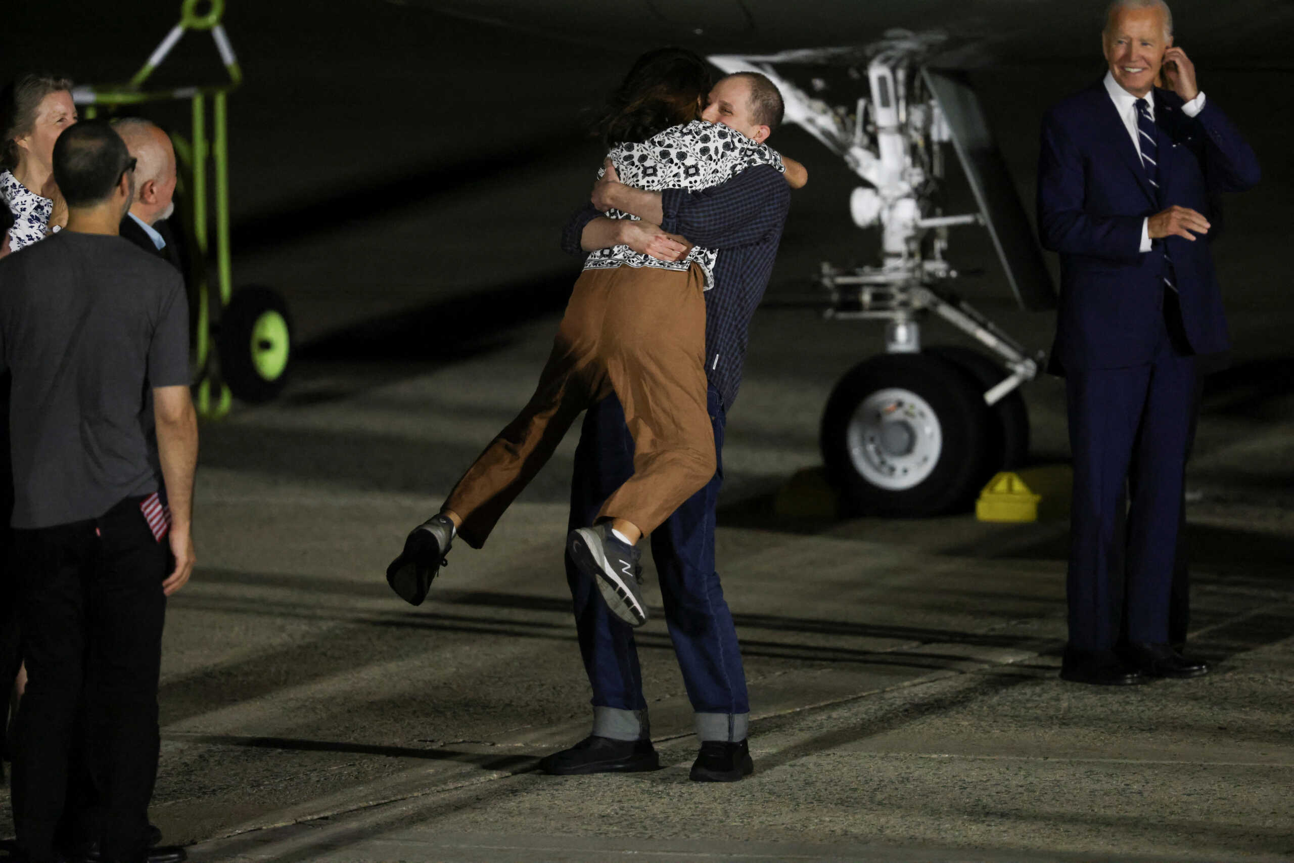 U.S. President Joe Biden looks on as Evan Gershkovich who was released from detention in Russia, is greeted by his mother Ella Milman, upon his arrival at Joint Base Andrews in Maryland, U.S., August 1, 2024. REUTERS