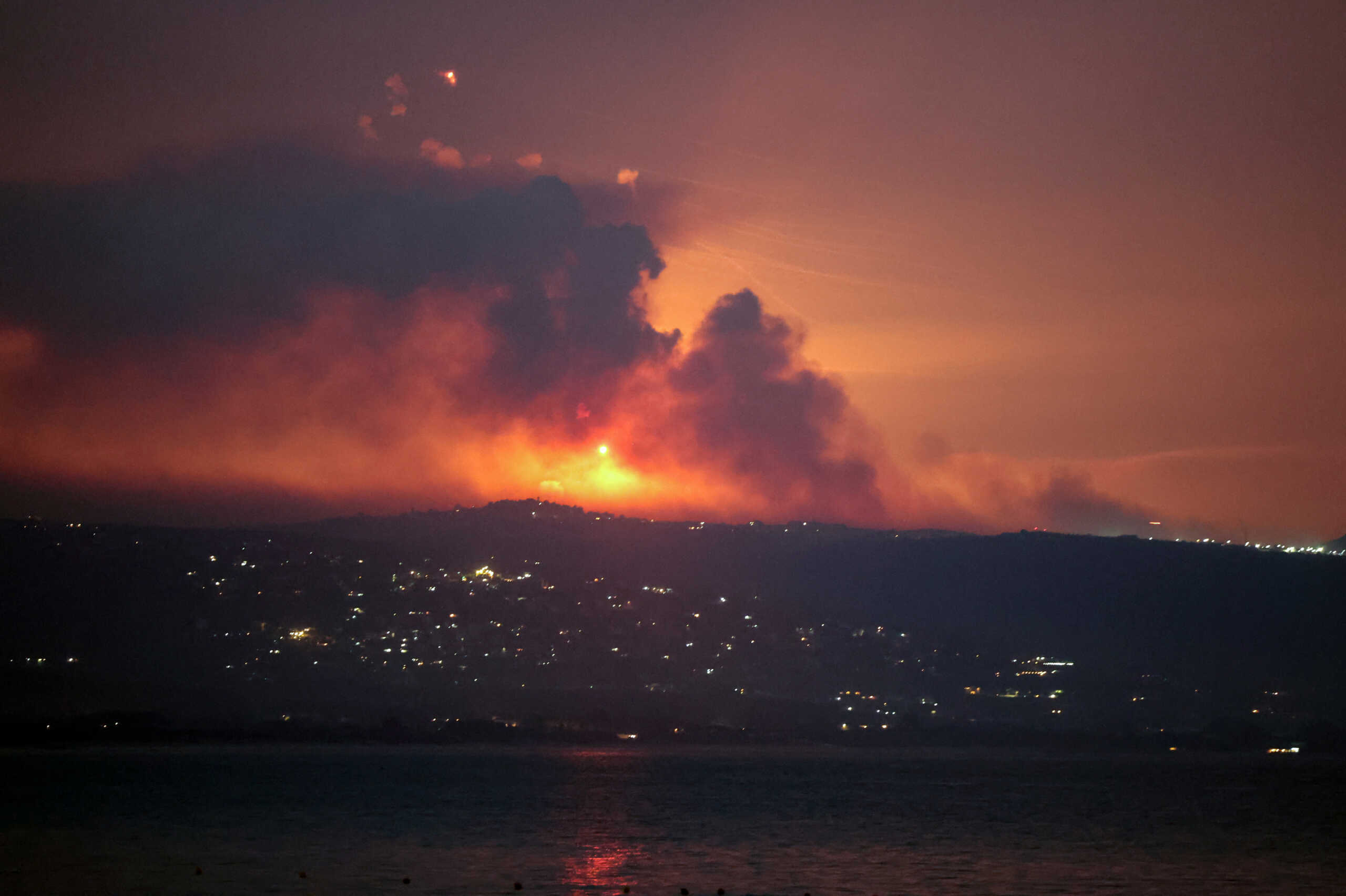 A view shows smoke and fire on the Lebanese side of the border with Israel, after Israel said it had noted armed group Hezbollah preparing to attack Israel and had carried out pre-emptive strikes on Hezbollah targets in Lebanon, as seen from Tyre, southern Lebanon August 25, 2024. REUTERS