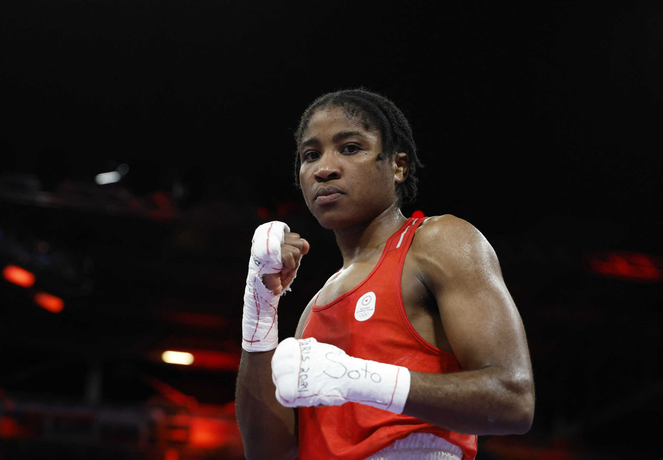 Paris 2024 Olympics - Boxing - Women's 75kg - Quarterfinal - North Paris Arena, Villepinte, France - August 04, 2024. Cindy Winner Djankeu Ngamba of Refugee Olympic Team reacts after winning her fight against Davina Michel of France. REUTERS