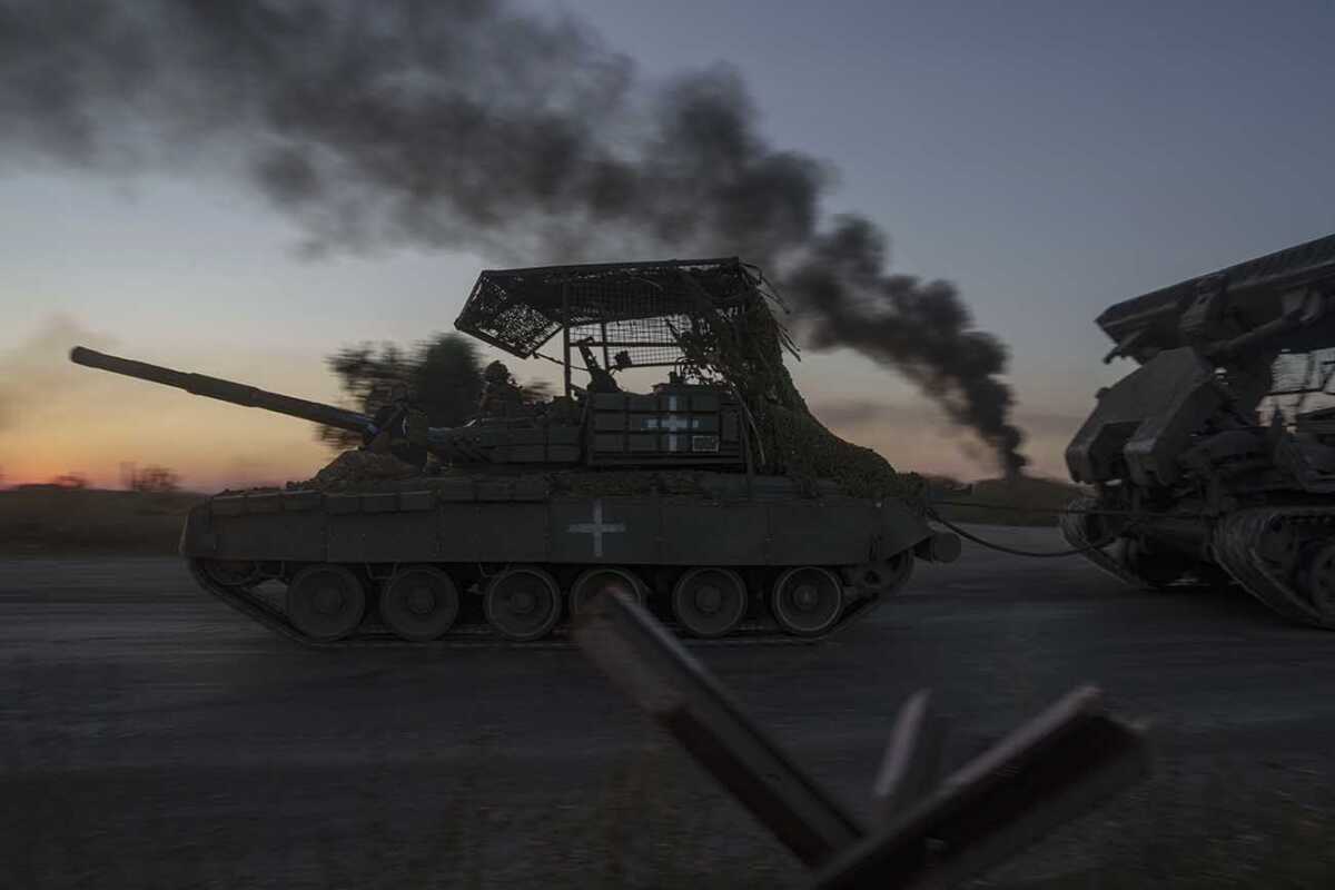FILE - Ukrainian servicemen ride atop a tank after returning from Russia near the Russian-Ukrainian border in Sumy region, Ukraine, on Saturday, Aug. 17, 2024. (AP Photo