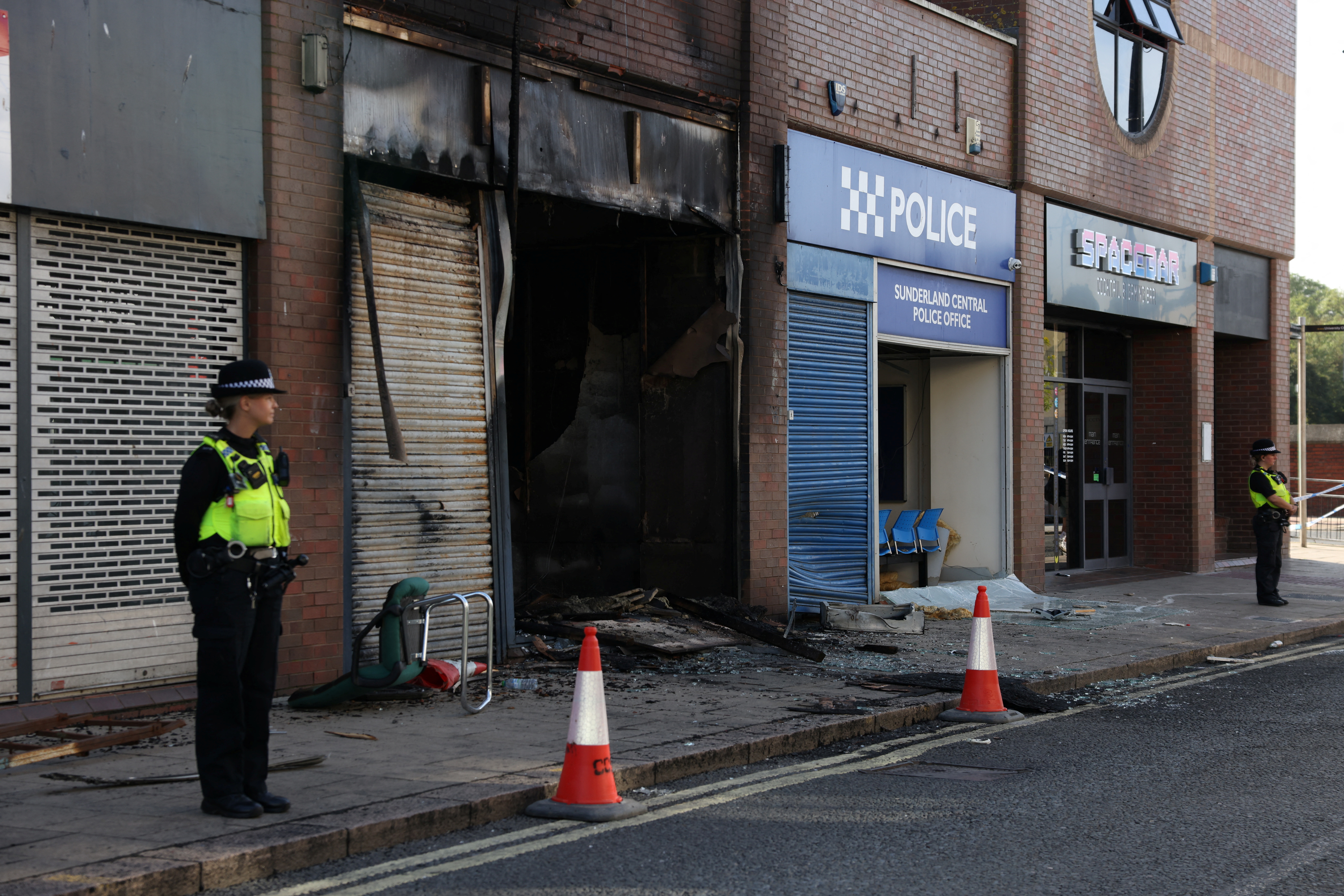 Police officers stand next to Sunderland Central Police Office after a night of violent anti-immigrant demonstrations, in Sunderland, Britain, August 3, 2024. REUTERS