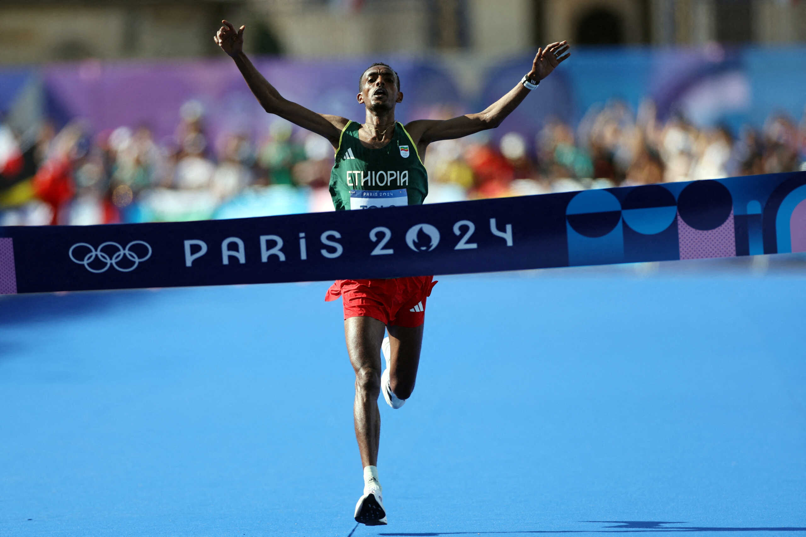 Paris 2024 Olympics - Athletics - Men's Marathon - Paris, France - August 10, 2024. Tamirat Tola of Ethiopia celebrates as he crosses the finish line at Invalides to win gold. REUTERS