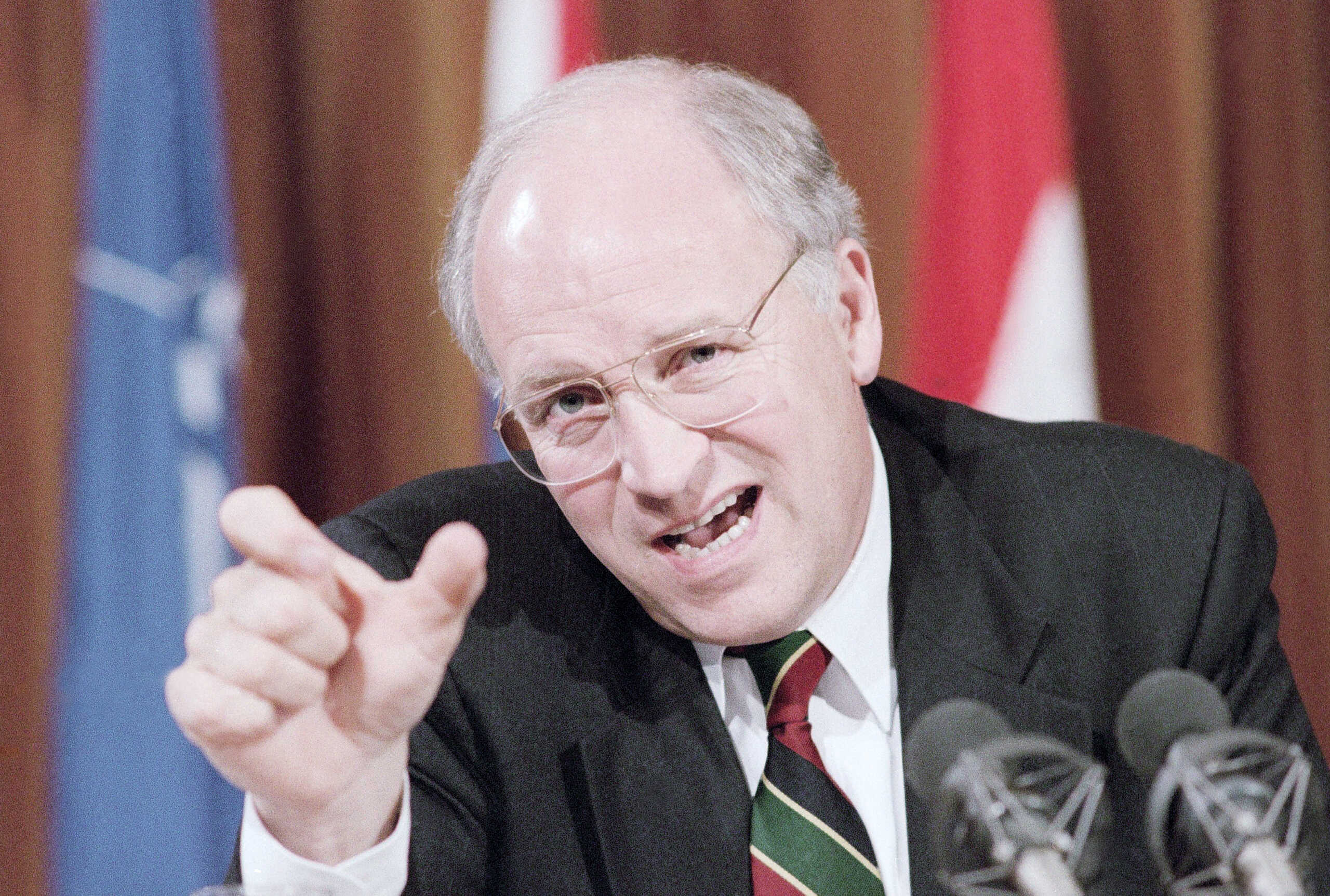 Secretary of Defense Dick Cheney gestures during a news conference at the conclusion of a two-day NATO meeting in Brussels, May 27, 1992. Cheney urged the NATO allies to pick up part of the yearly tab of at least $250 million for depots that house tanks, guns and other military equipment throughout Europe. Cheney sought help in footing the bill because of pressure at home to slash spending. (AP Photo