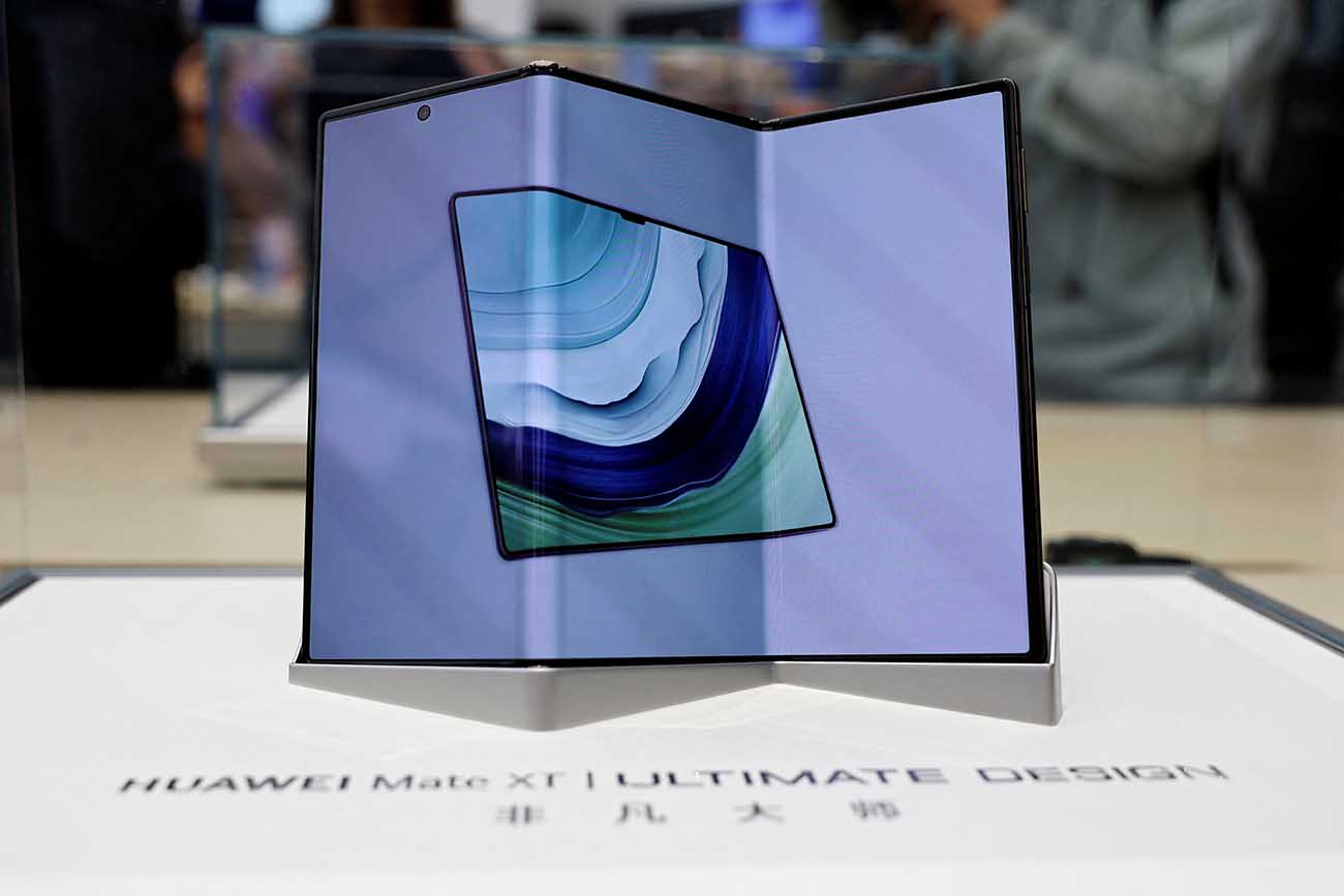Huawei's new tri-foldable smartphone Mate XT is seen displayed in a glass case at a Huawei flagship store in Beijing, China September 10, 2024. REUTERS