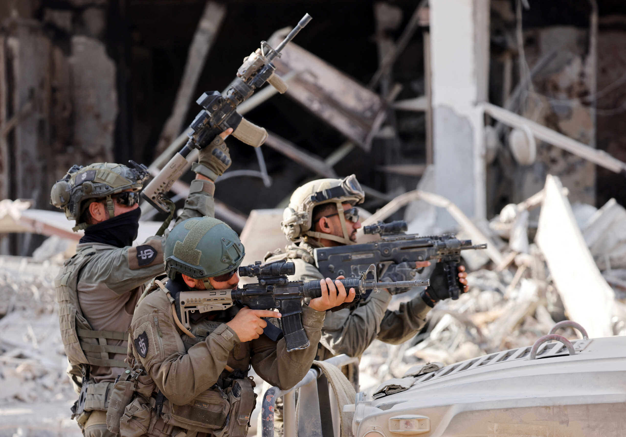 Israeli soldiers hold weapons, amid the ongoing ground operation of the Israeli army against Palestinian Islamist group Hamas, in the Gaza Strip, September 13, 2024. REUTERS