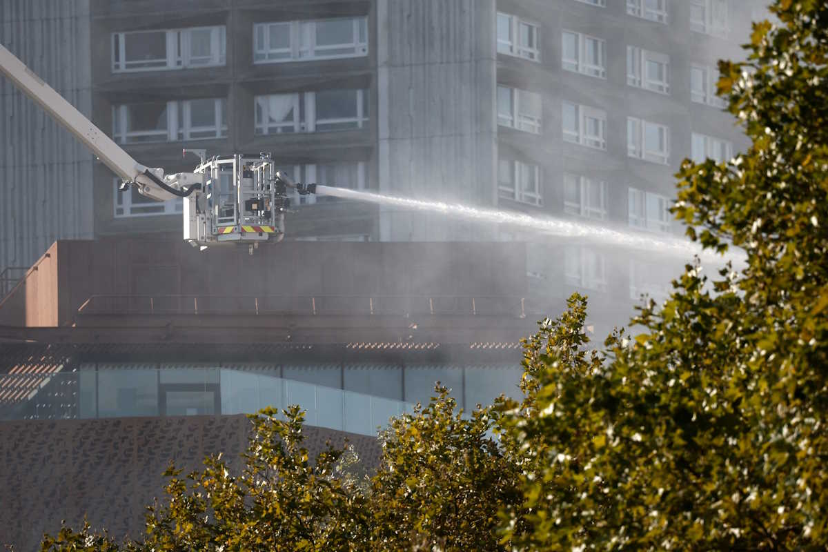 French firefighters spray water after a fire broke out at a residential apartment block during building construction at Porte d'Ivry in Paris, France, September 17, 2024. REUTERS