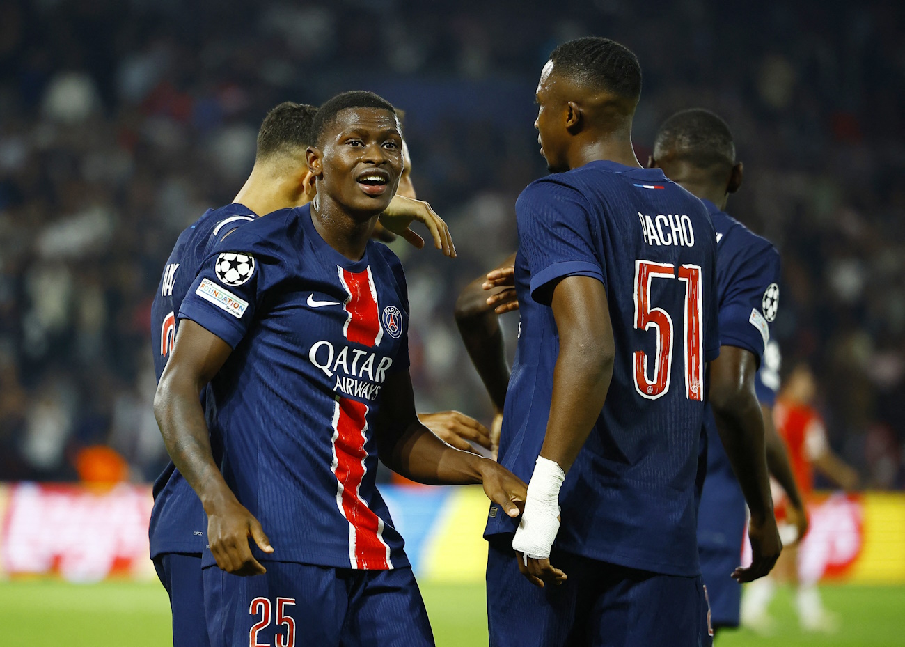 Soccer Football - Champions League - Paris St Germain v Girona - Parc des Princes, Paris, France - September 18, 2024 Paris St Germain's Nuno Mendes celebrates scoring their first goal with Willian Pacho REUTERS