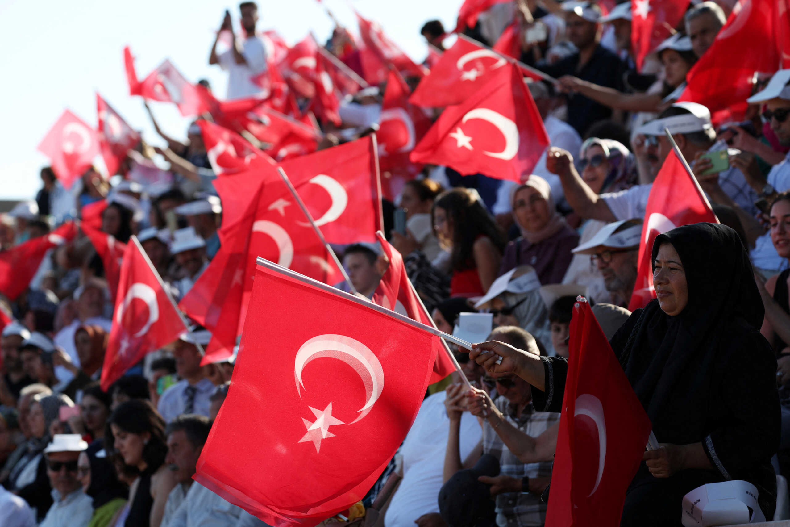Relatives of the newly graduated naval cadets wave national flags during a graduation ceremony at the Turkish Naval Academy in Istanbul, Turkey August 31, 2024. REUTERS