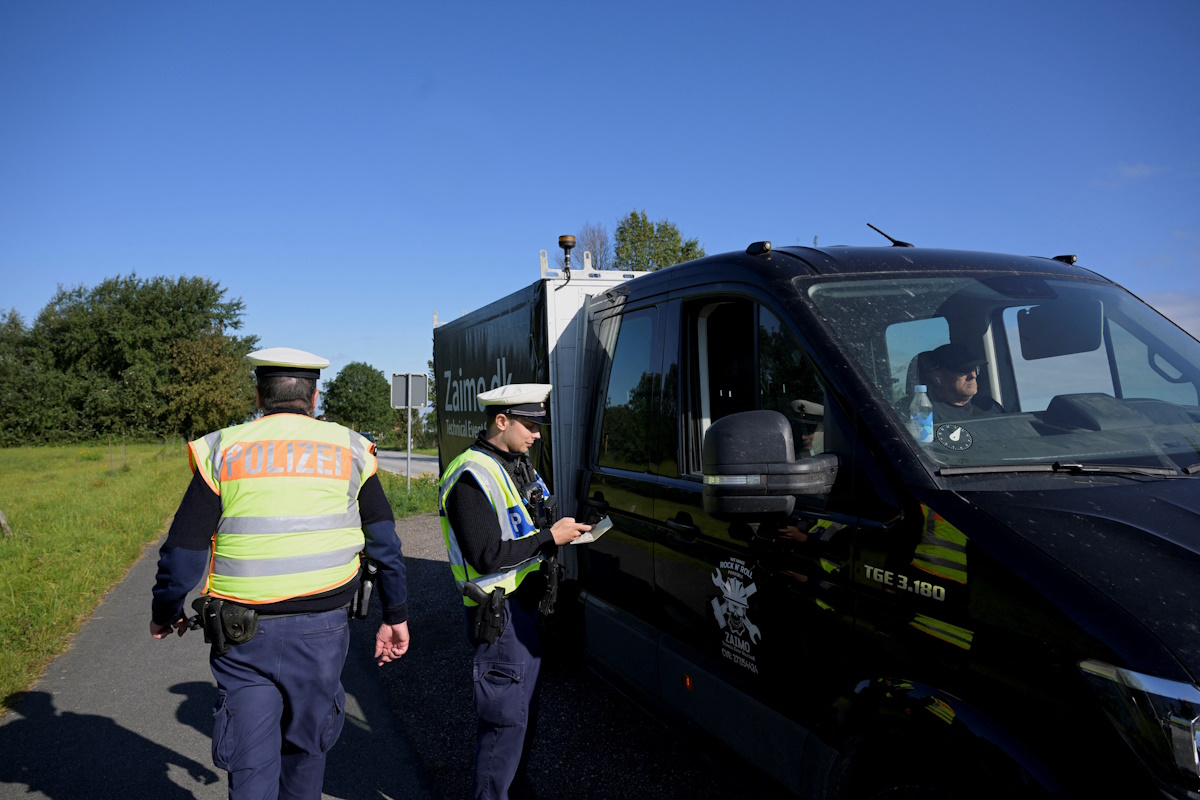 German police officers check a vehicle at a border with Denmark, as all German land borders are subject to random controls to protect internal security and reduce irregular migration, in Boeglum, Germany, September 16, 2024. REUTERS