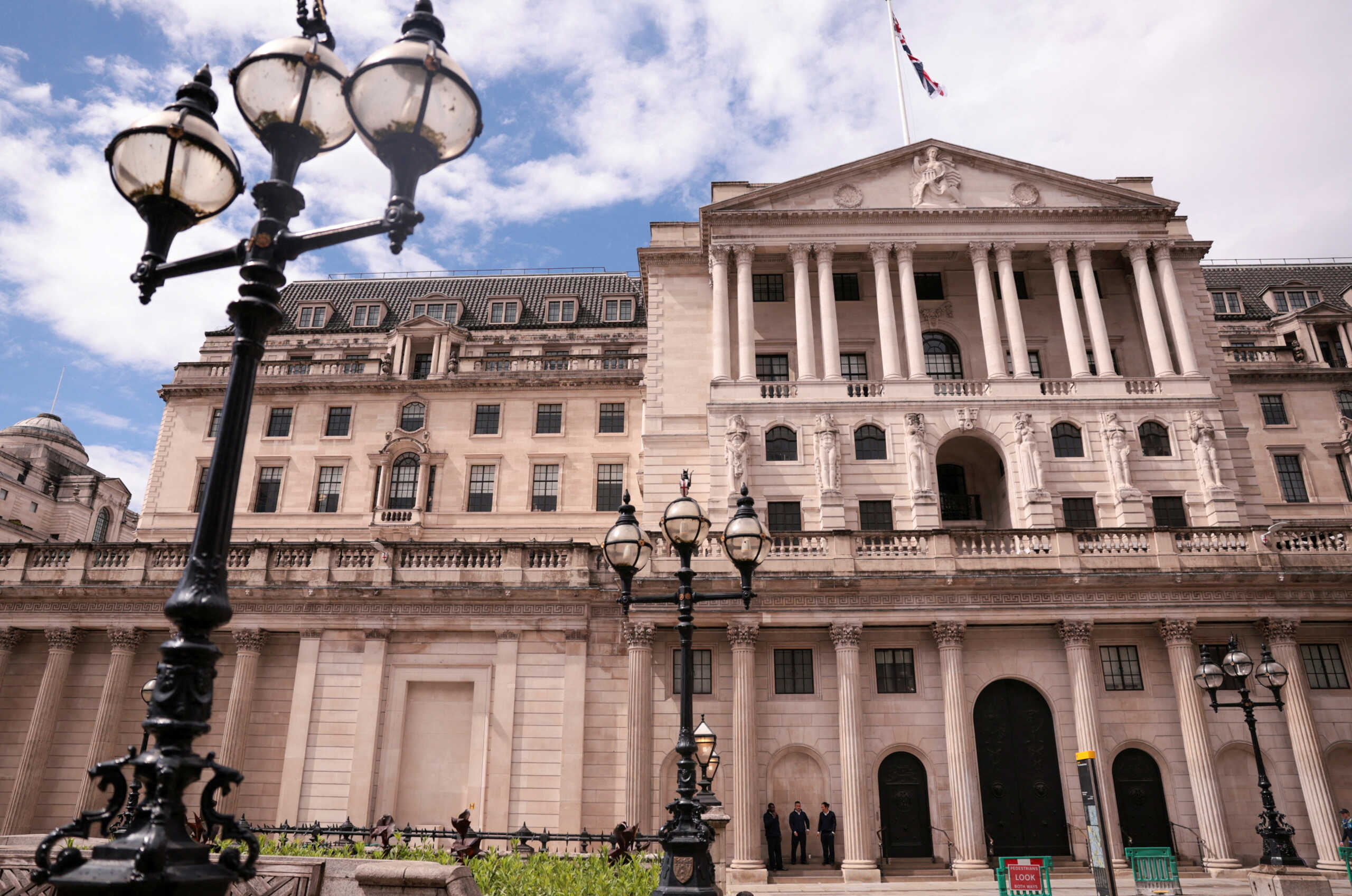 FILE PHOTO: People stand next to the Bank of England, in London, Britain, July 7, 2024. REUTERS