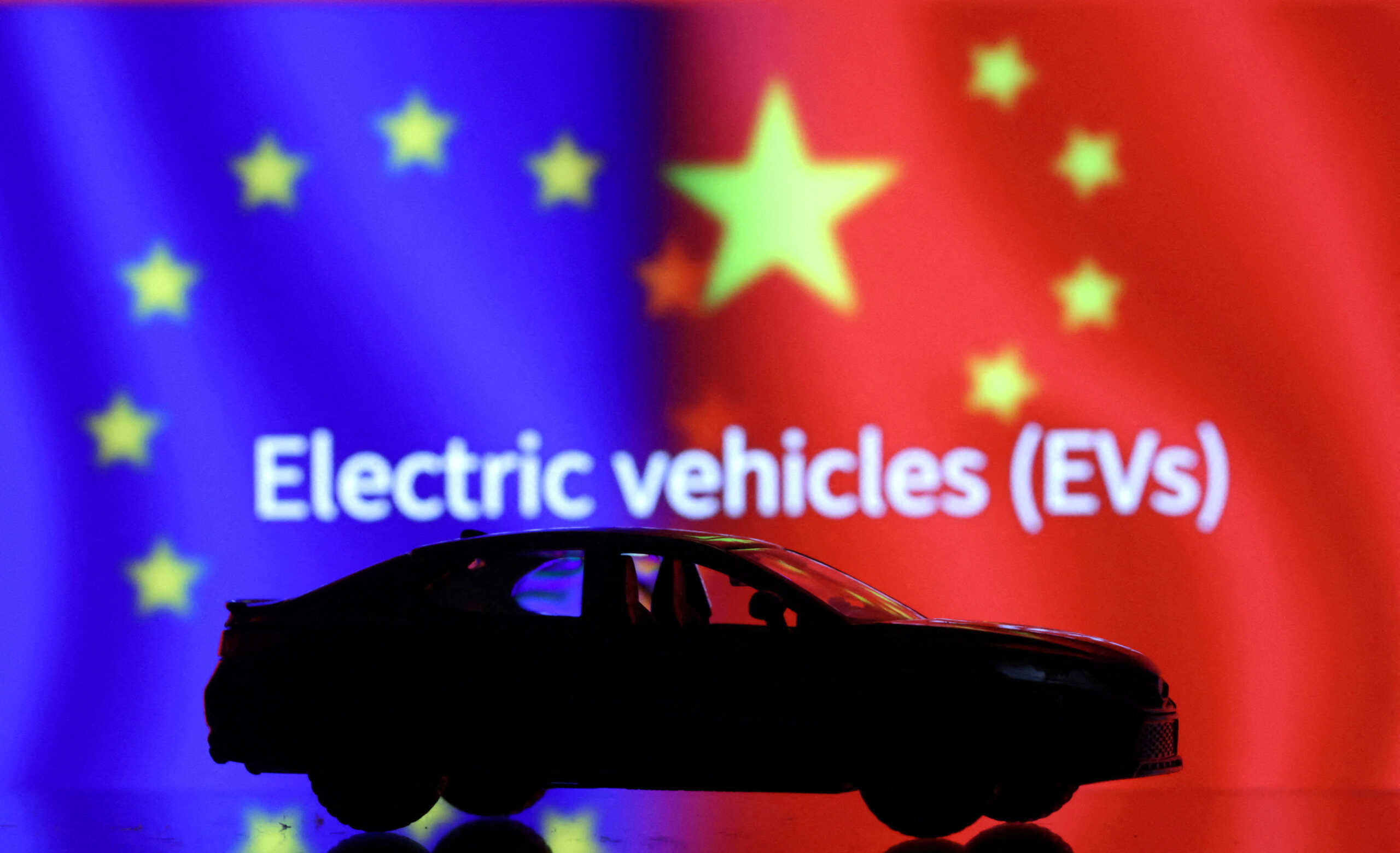 FILE PHOTO: Car miniature, "Electric vechicles (EVs)" words, EU and Chinese flags are seen in this illustration taken, September 26, 2023. REUTERS