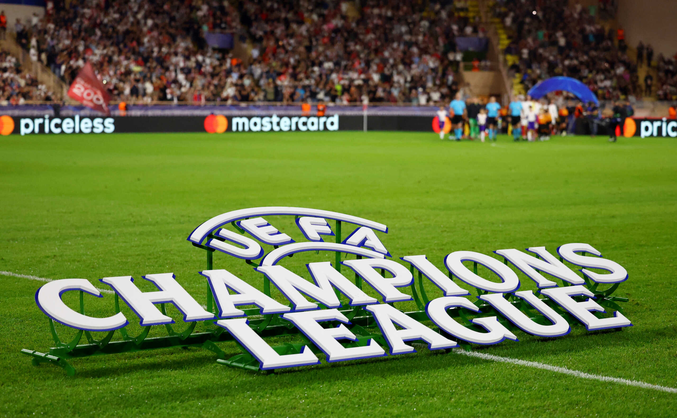 Soccer Football - Champions League - AS Monaco v FC Barcelona - Stade Louis II, Monaco - September 19, 2024 Champions League signage is seen on the pitch before the match REUTERS