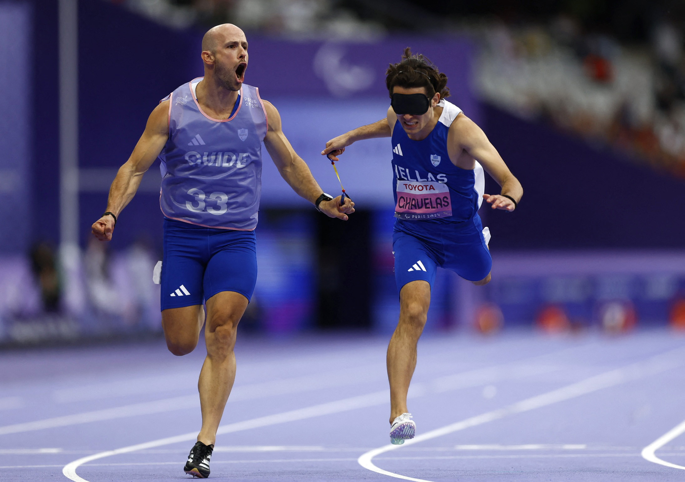 Paris 2024 Paralympics - Athletics - Men's 100m - T11 Final - Stade de France, Saint-Denis, France - September 5, 2024 Athanasios Ghavelas of Greece and guide Ioannis Nyfantopoulos cross the line to win gold REUTERS