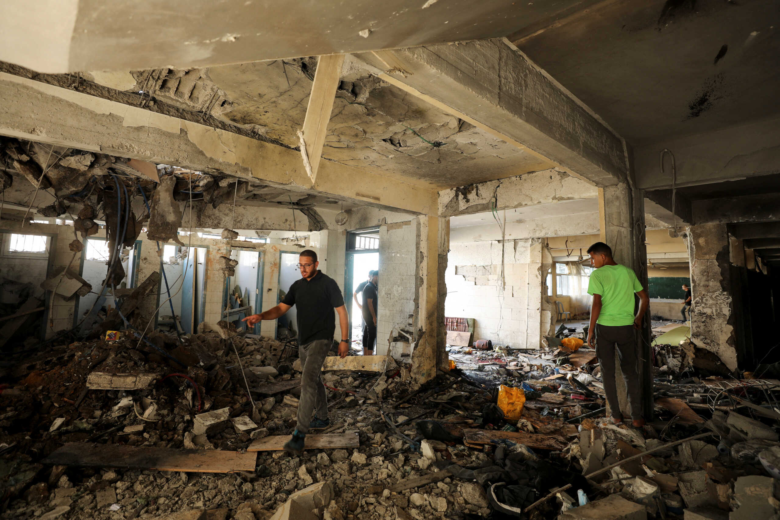 Palestinians inspect a school, which was sheltering displaced people, after it was hit by an Israeli strike, amid the Israel-Hamas conflict, in Gaza City, September 21, 2024. REUTERS