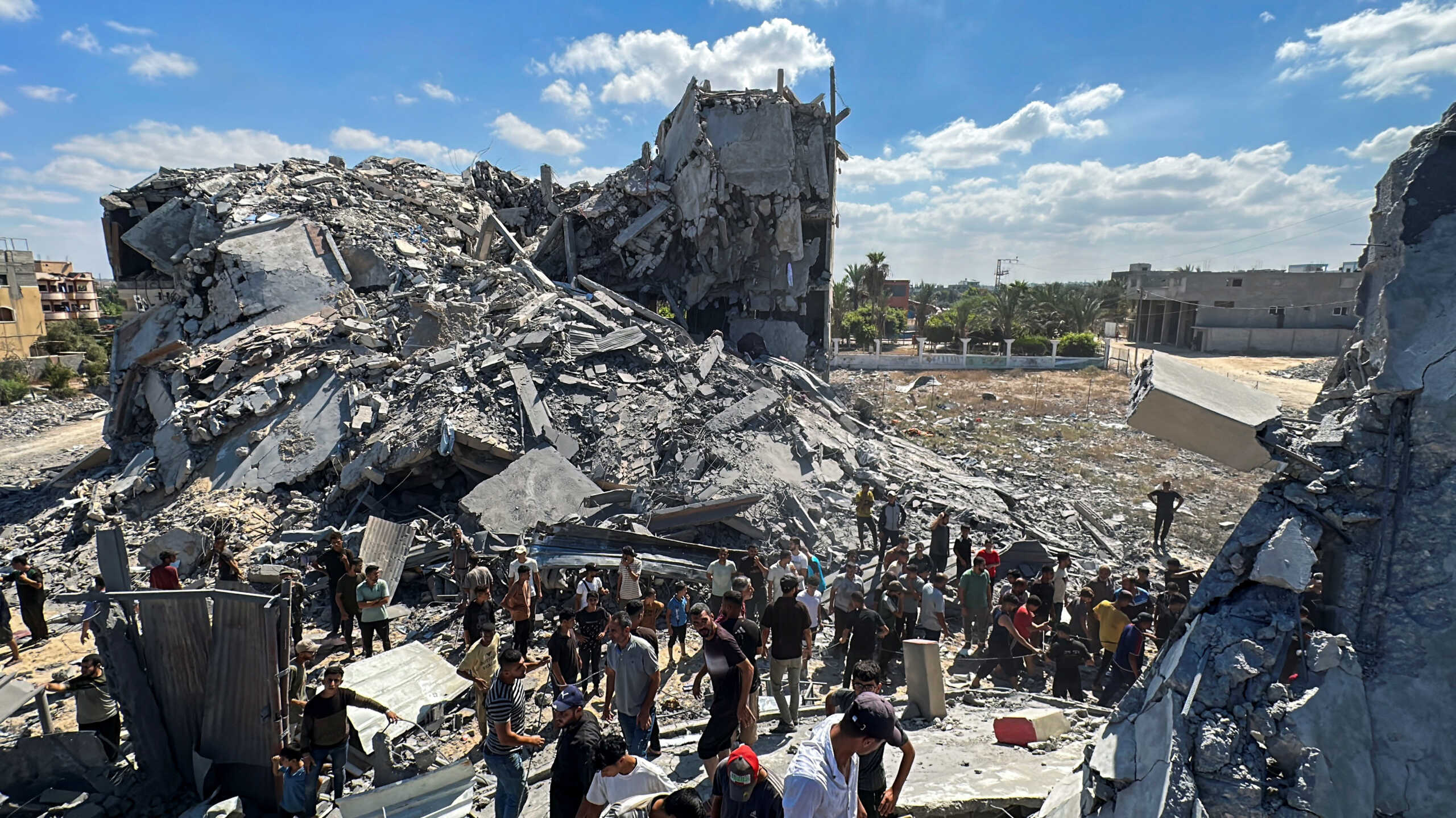 Palestinians gather at the site of an Israeli strike on a residential building, amid the Israel-Hamas conflict, in Nuseirat in the central Gaza Strip September 30, 2024. REUTERS