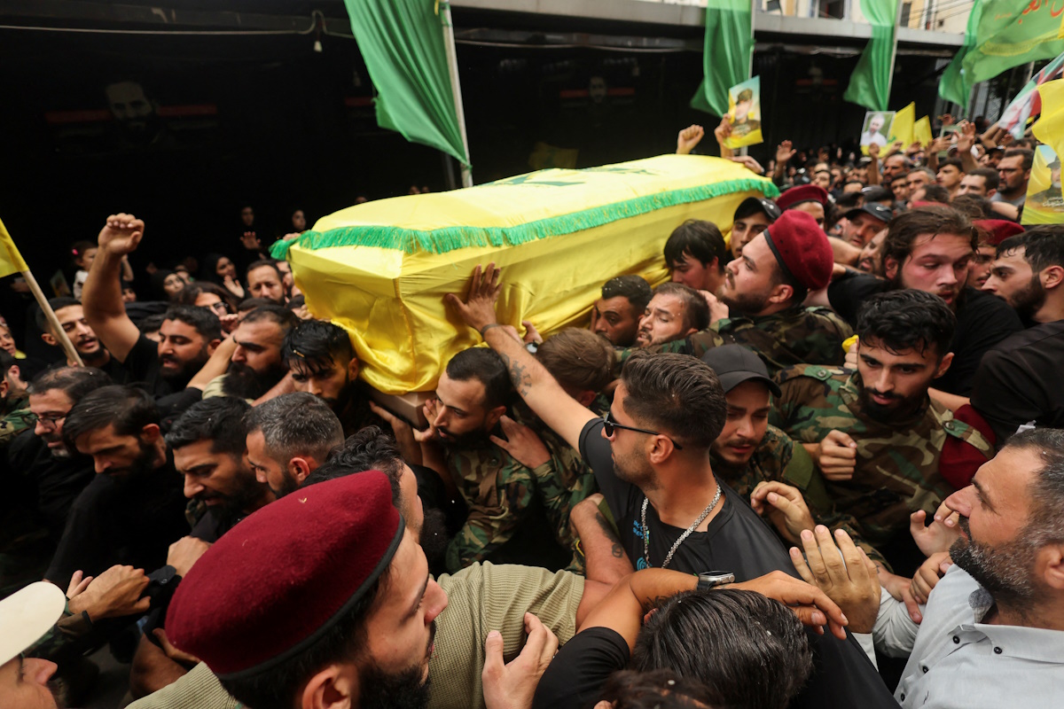 Mourners carry a coffin during the funeral of Hezbollah senior leader Ibrahim Aqil and Hezbollah member Mahmoud Hamad, who were killed in Friday's Israeli strike on Beirut's southern suburbs, in Beirut, Lebanon, September 22, 2024. REUTERS
