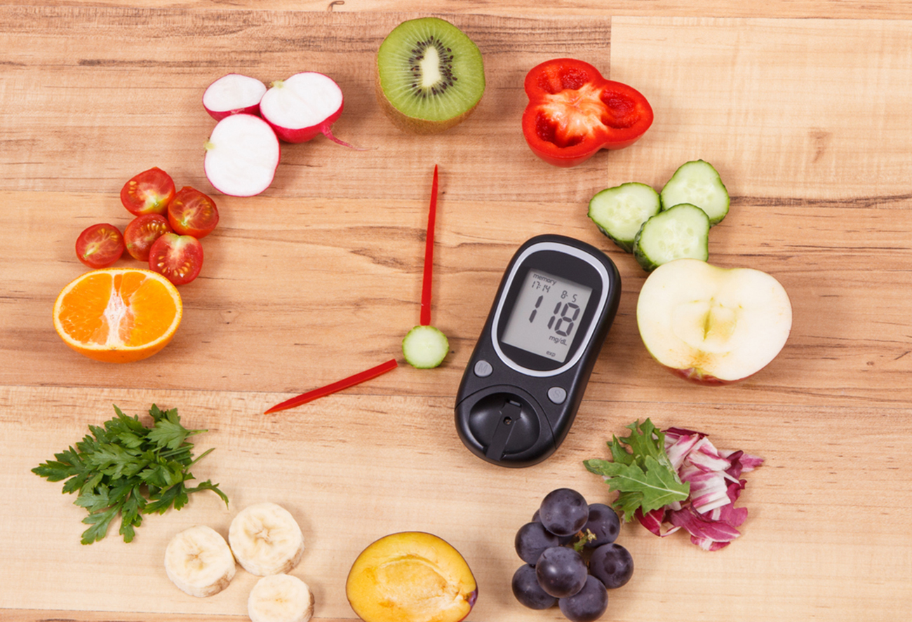 Glucometer with clock made of ripe fruits and vegetables, concept of healthy breakfast for diabetics
