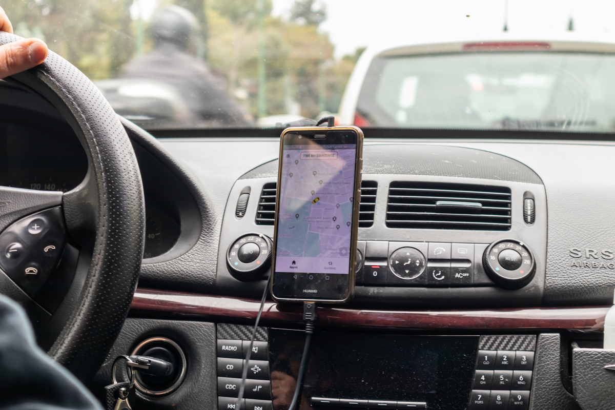 March 31st, 2019, Greece Athens. Mobile phone, navigation maps on the screen, taxi car interior