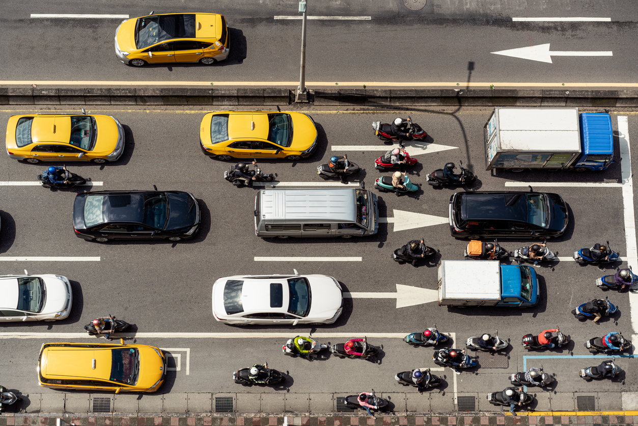A view from above of scooter and car traffic on a major inner city street in Taipei,Taiwan.