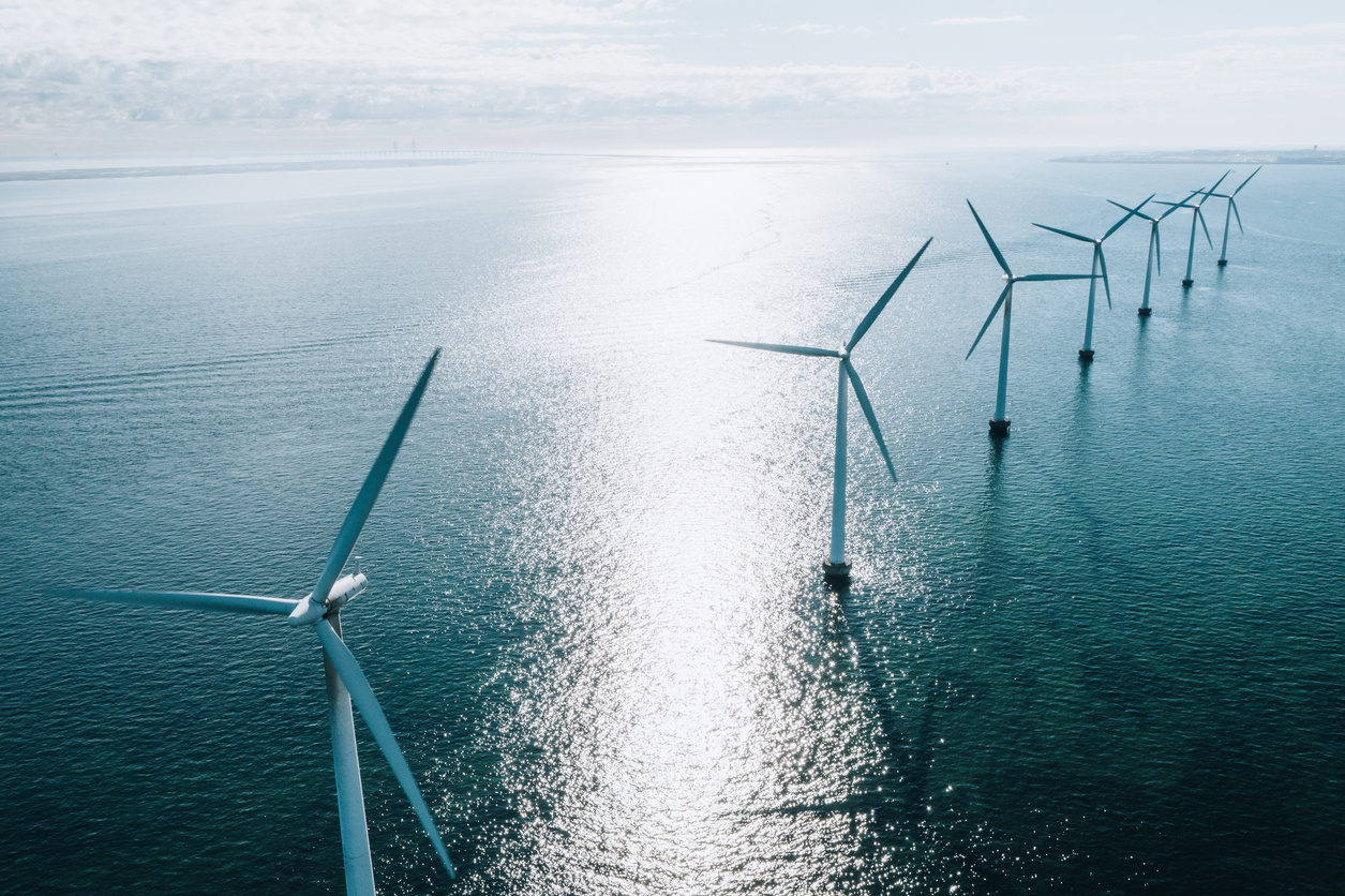 Coastal wind turbines at the oceanic windmill Middelgrunden, situated just outside Copenhagen. These iconic turbines, which can be seen from most places within this capital city, are a symbol of a future with green cities and sustainable energy in Denmark.
