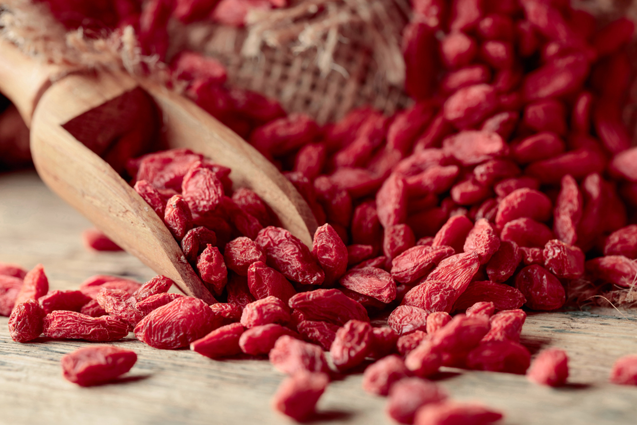 Dried goji berries on an old wooden table.