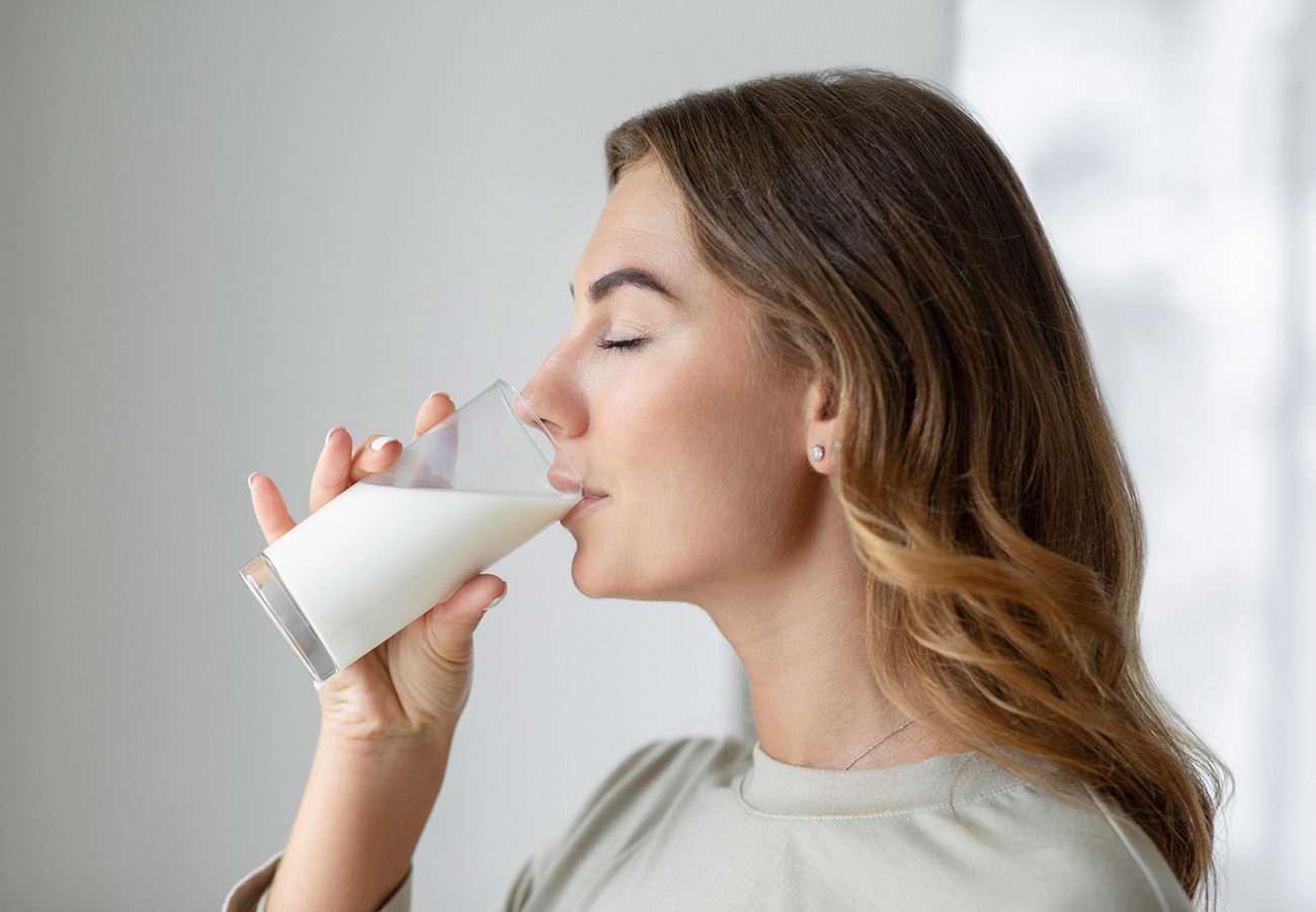 Woman drinking a glass of milk