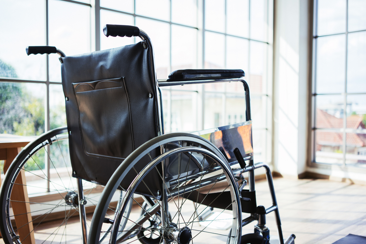 Wheelchair in empty hospital near light from the window