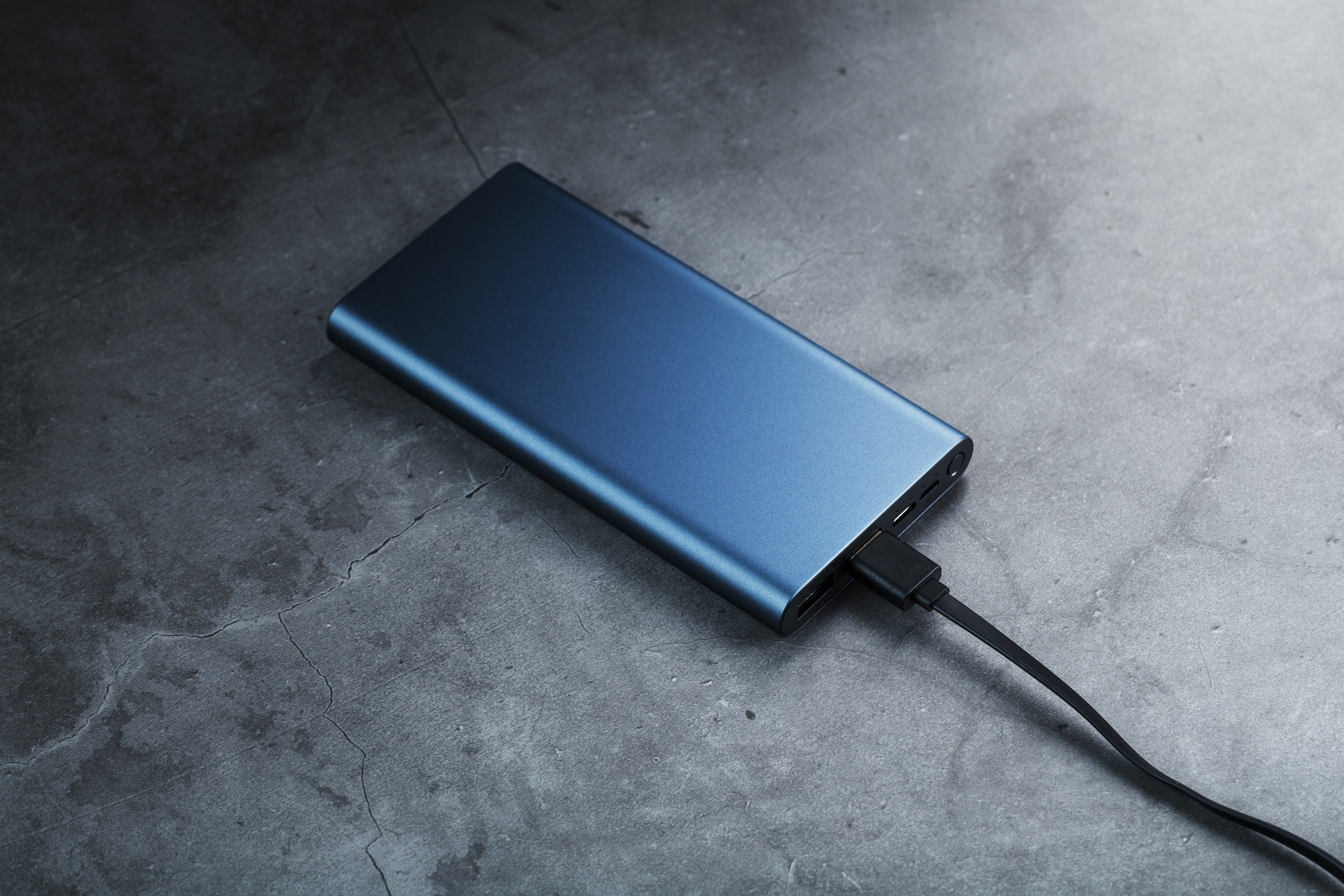 Battery Power supply for recharging gadgets and electronic devices on a dark background