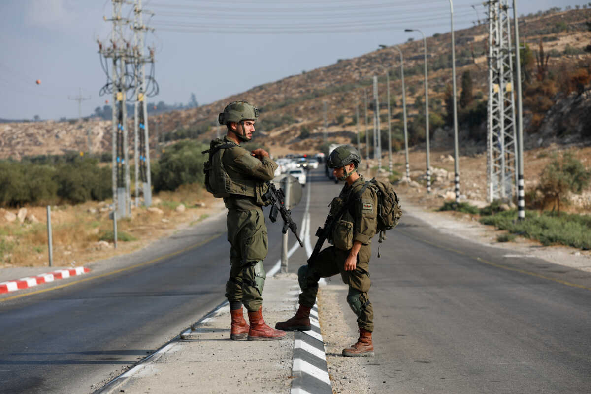 Israeli forces stand guard near a shooting scene, near Hebron in the Israeli-occupied West Bank September 1, 2024.  REUTERS