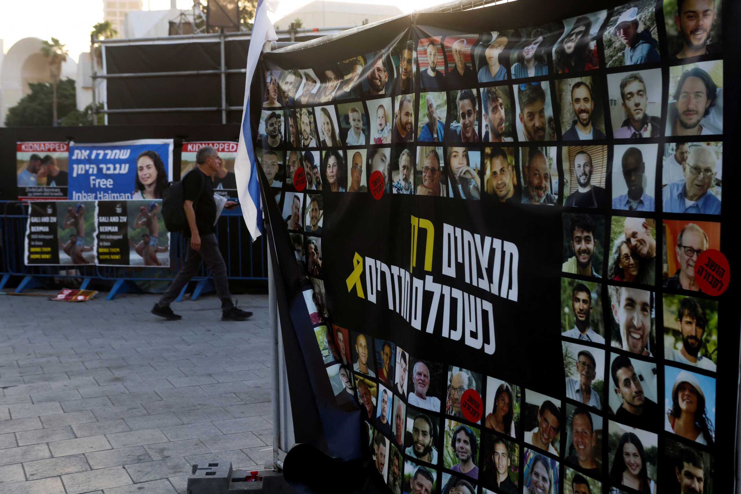 A man walks past images of people taken hostage or killed during the deadly October 7 attack, amid the ongoing conflict in Gaza between Israel and Hamas, in Tel Aviv, Israel September 15, 2024. REUTERS