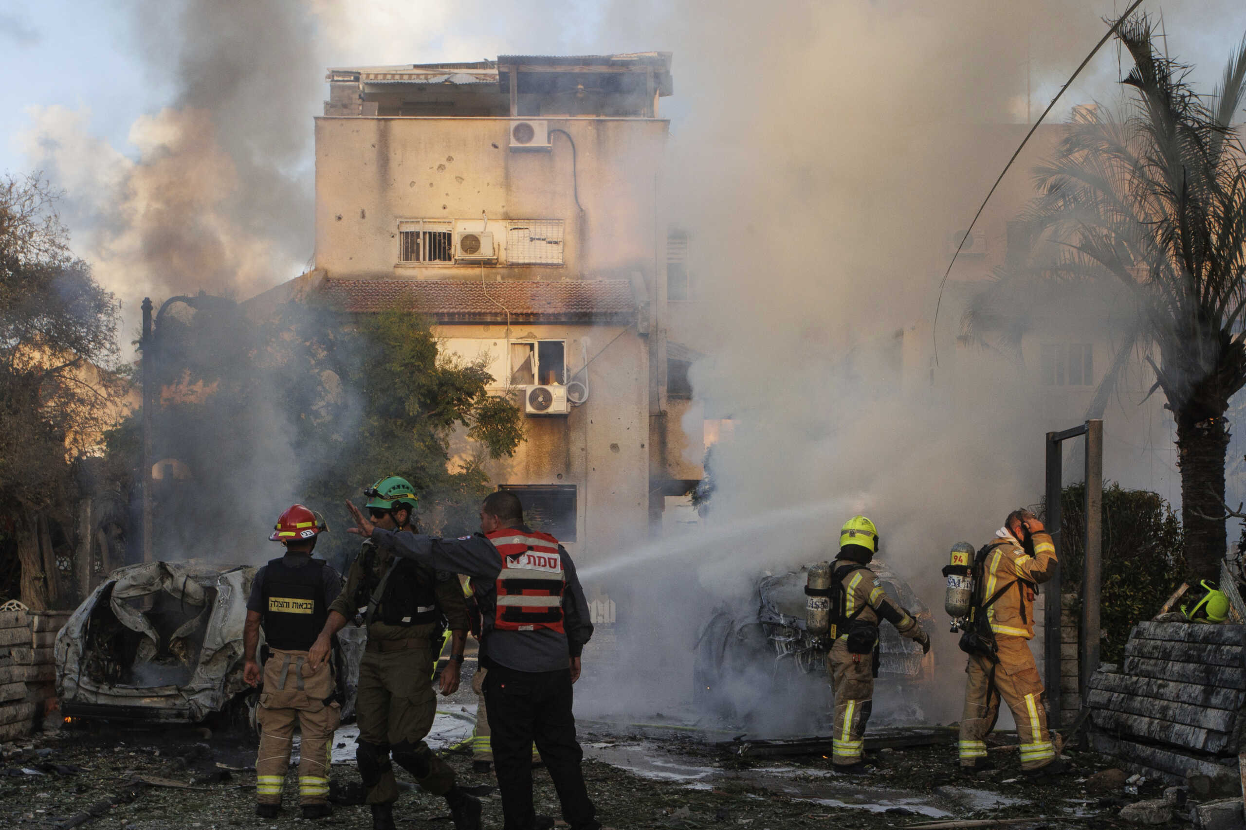 Israeli security and rescue forces work at the site hit by a rocket fired from Lebanon, in Kiryat Bialik, northern Israel, on Sunday, Sept. 22, 2024. (AP Photo