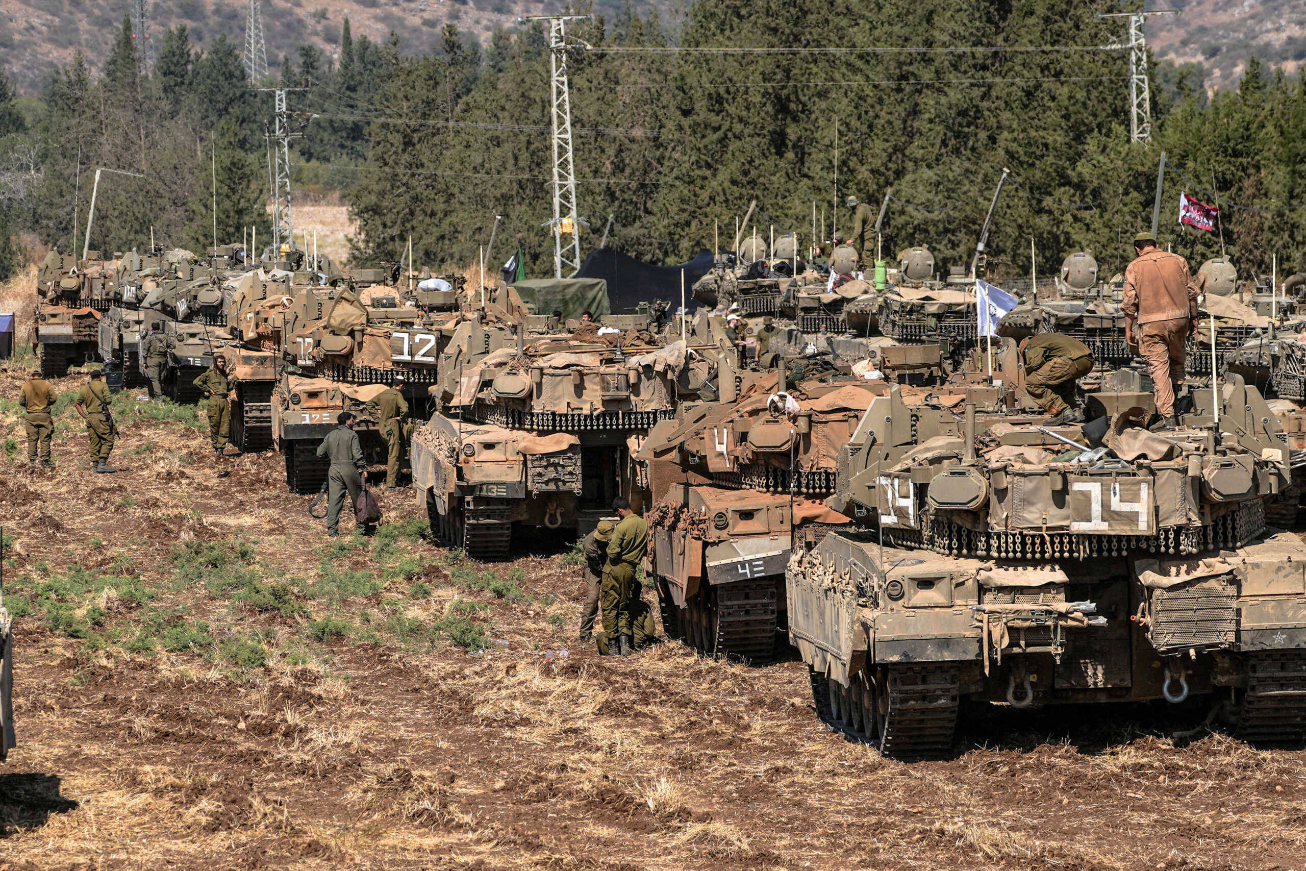 Israeli soldiers work among tanks, amid cross-border hostilities between?Hezbollah?and Israel, in northern Israel, September 27, 2024. REUTERS