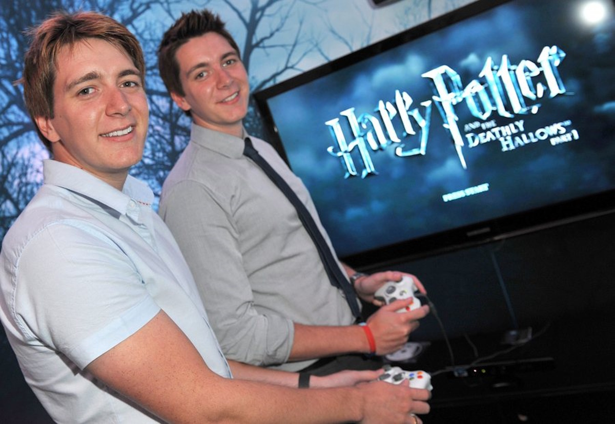 epa02292011 The actor-twins Oliver (L) and James Phelps, known from the Harry Potter movies as 'Weasley Twins Fred and George', pose at the booth of the company 'Electronic Arts' with a Harry Potter Game during the fair 'Gamescom' in Cologne, Germany, 18 August 2010. The computer game-fair 'Gamescom' takes place between the 18 August and the 22 August 2010 in Cologne.  EPA