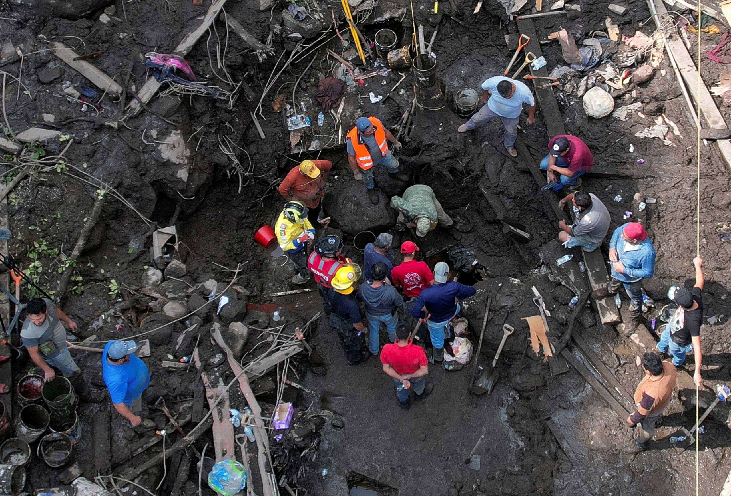 A drone view shows volunteers and rescue teams searching for people trapped in their homes under the mud after a landslide in San Luis Ayucan, on the outskirts of Mexico City, Mexico September 14, 2024. REUTERS