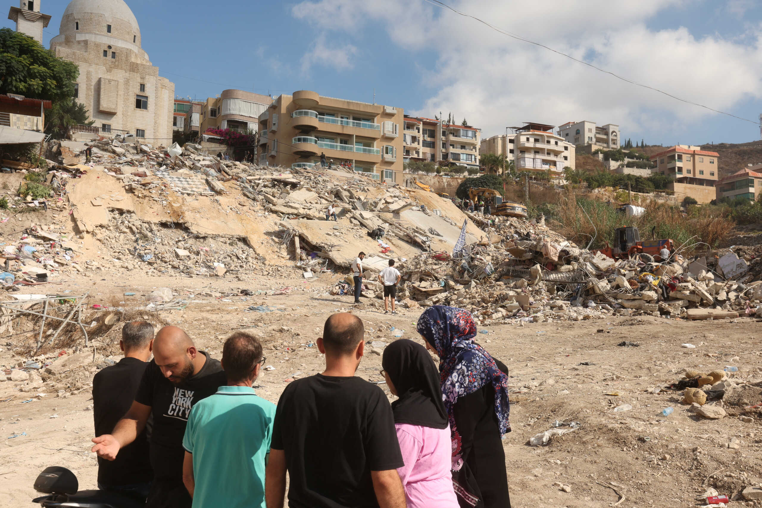 People inspect the damage at the site of Sunday's Israeli attack on the city of Ain Deleb, amid the ongoing hostilities between Hezbollah and Israeli forces, in southern Lebanon September 30, 2024. REUTERS
